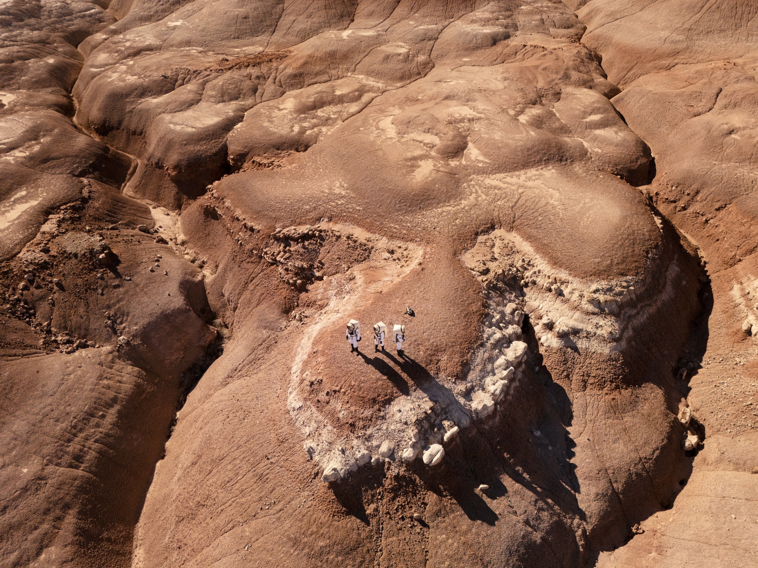 Commander Rym Chaïd, Crew Engineer Ricardo J. Gonzalez, and the Crew Journalist during an EVA to simulate emergency medical responses on Sol 9 at Mars Desert Research Station outside of Hanksville, Utah on October 21, 2025.