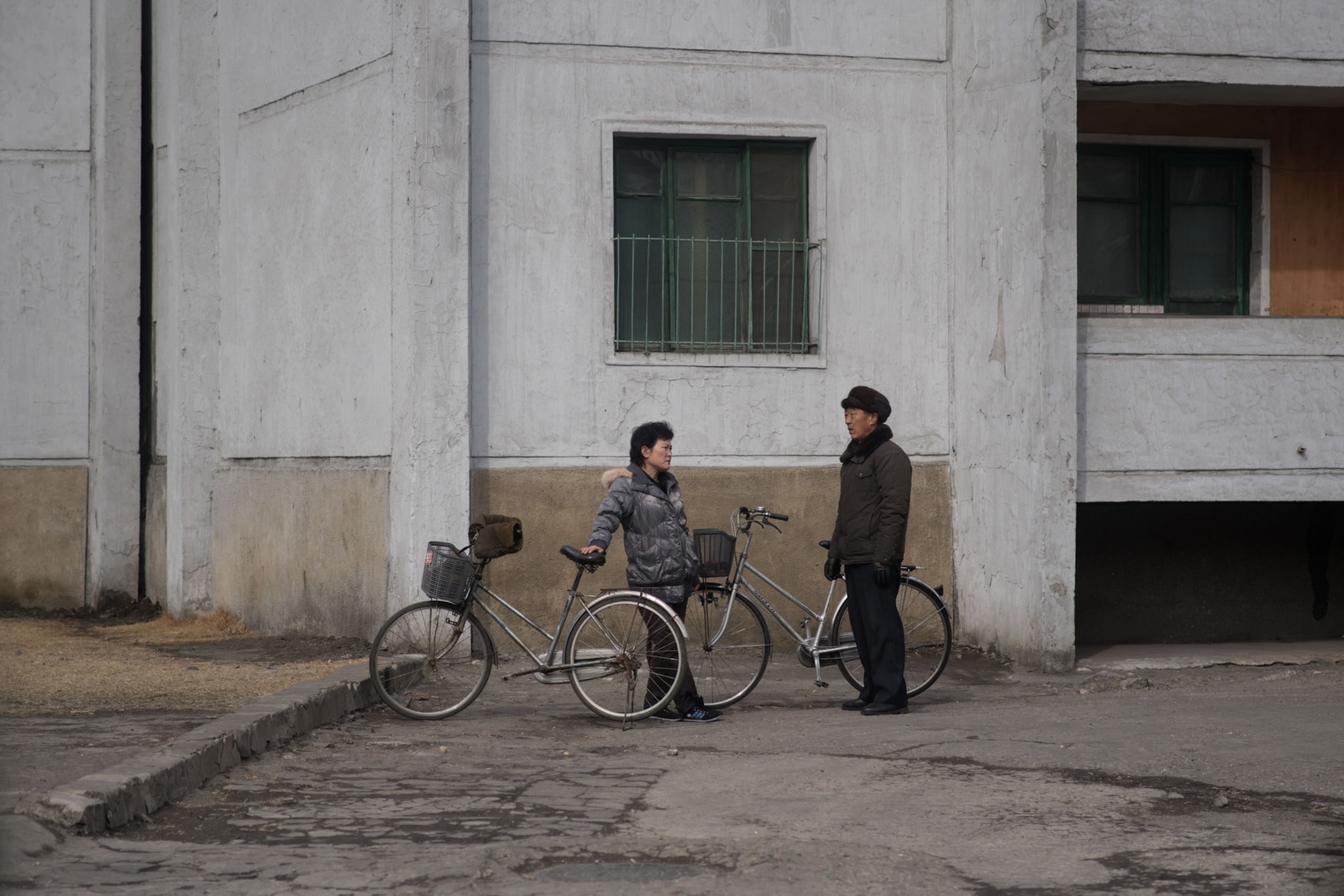 people standing near bikes in North Korea