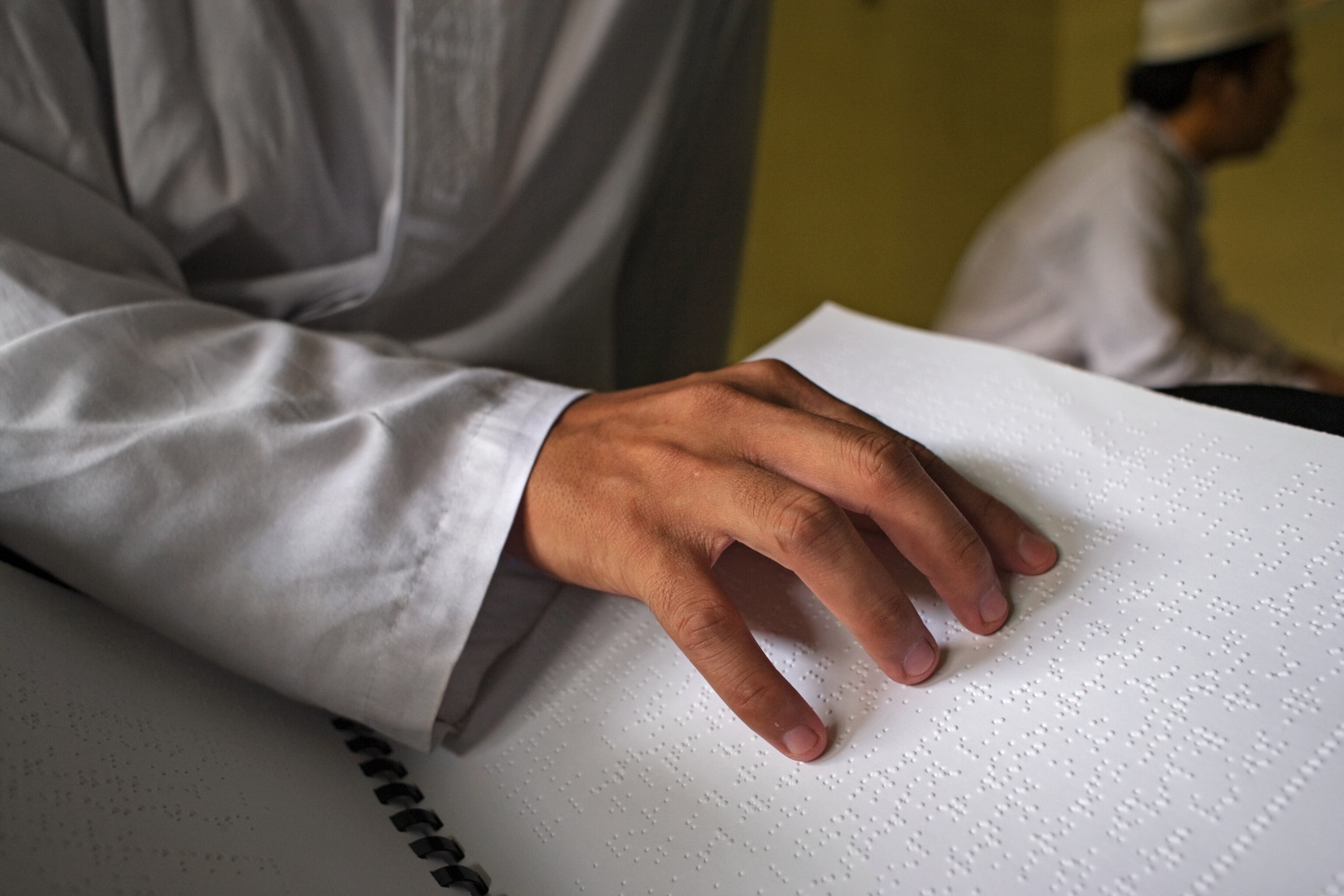 a blind student reading at Yayasan Raudlatul Makfufin in South Jakarta