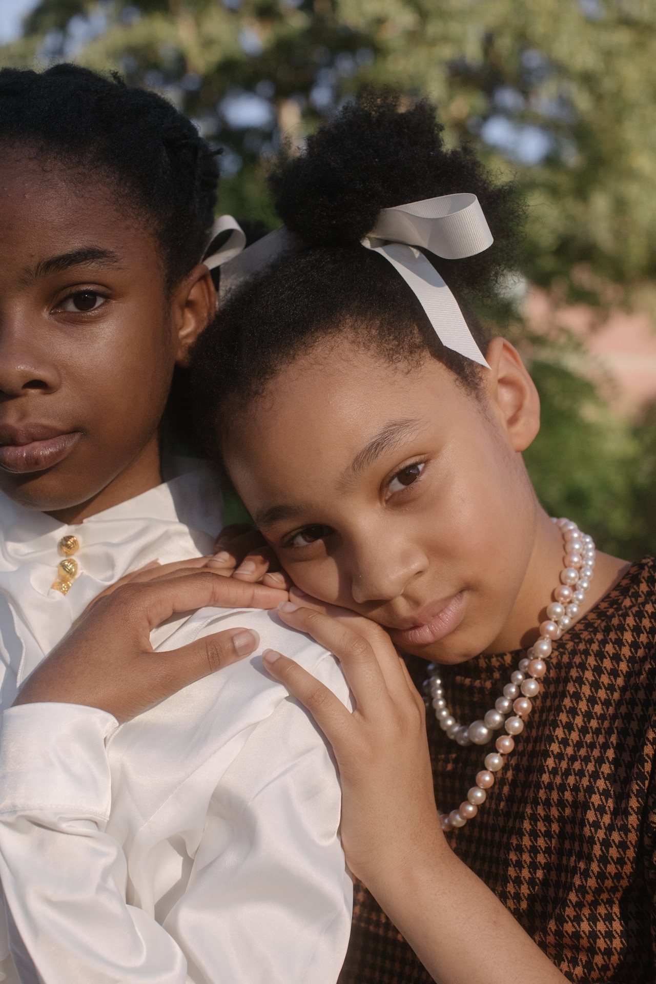 A young girl embracing her sister