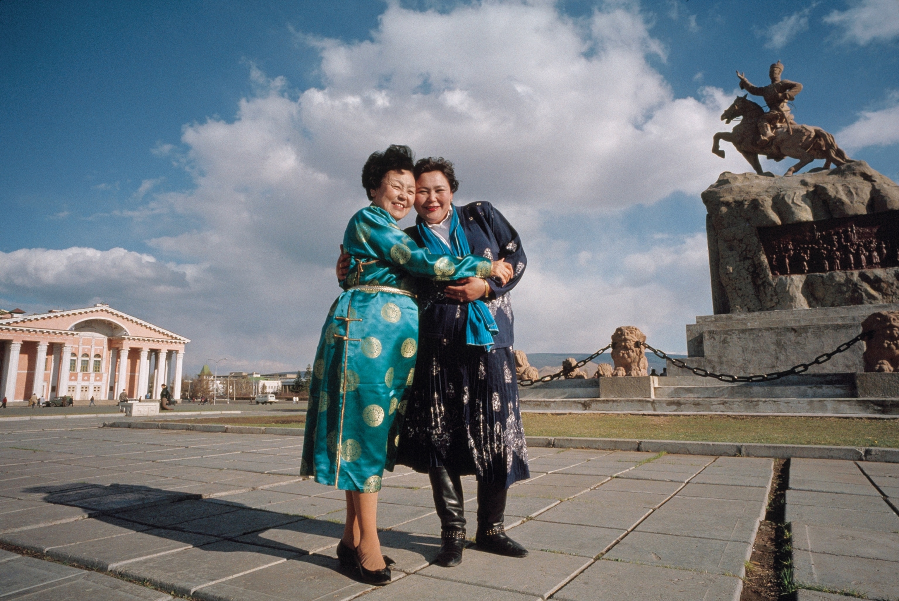 two asian women embracing before the camera.