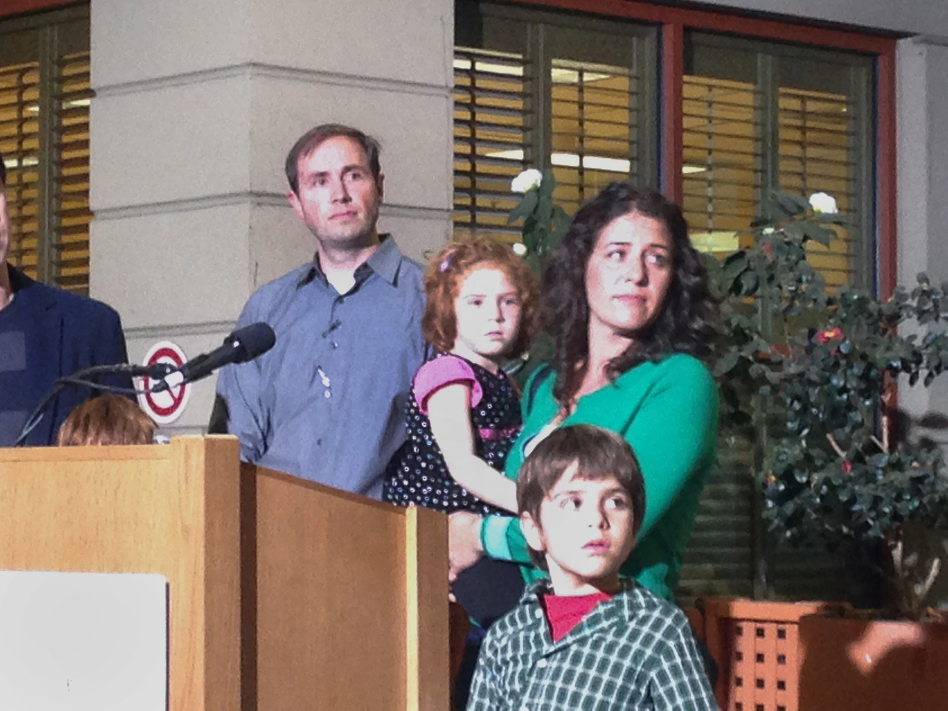 In this photo taken with a mobile phone, Jessica Tomei holds her 4-year-old daughter, Sofia Jarvis, during a news conference at Lucille Packard Children's Hospital at Stanford University on Monday, Feb. 24, 2014, in Palo Alto, Calif. Sofia is one of a handful of California children who has been diagnosed with a rare polio-like syndrome that has left her arm paralyzed. Stanford researchers say there is a possibility of an emerging infectious polio-like syndrome in California.