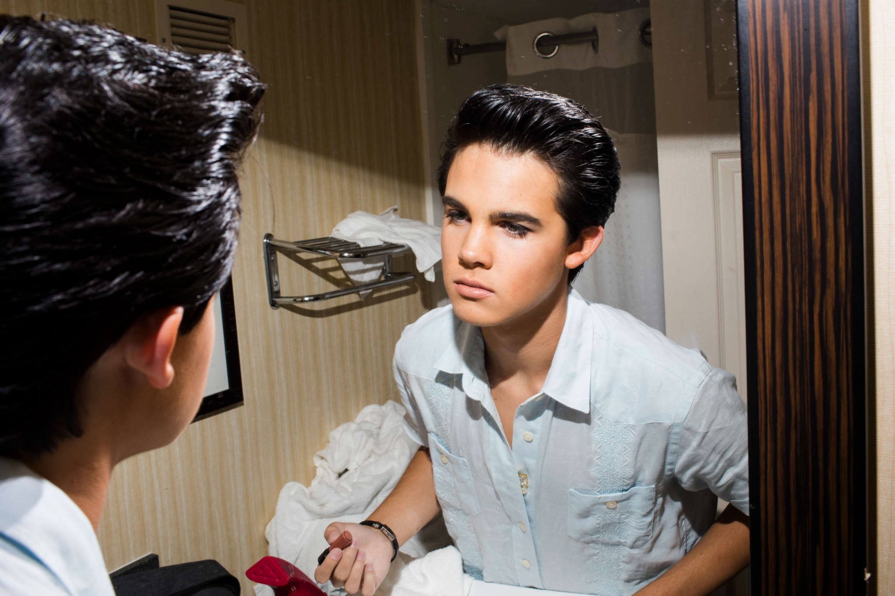 an Elvis tribute artist applying makeup