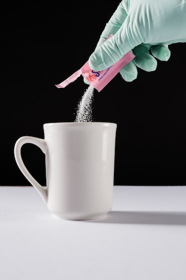 Studio shoot with black backdrop showing packets of artificial sweeteners