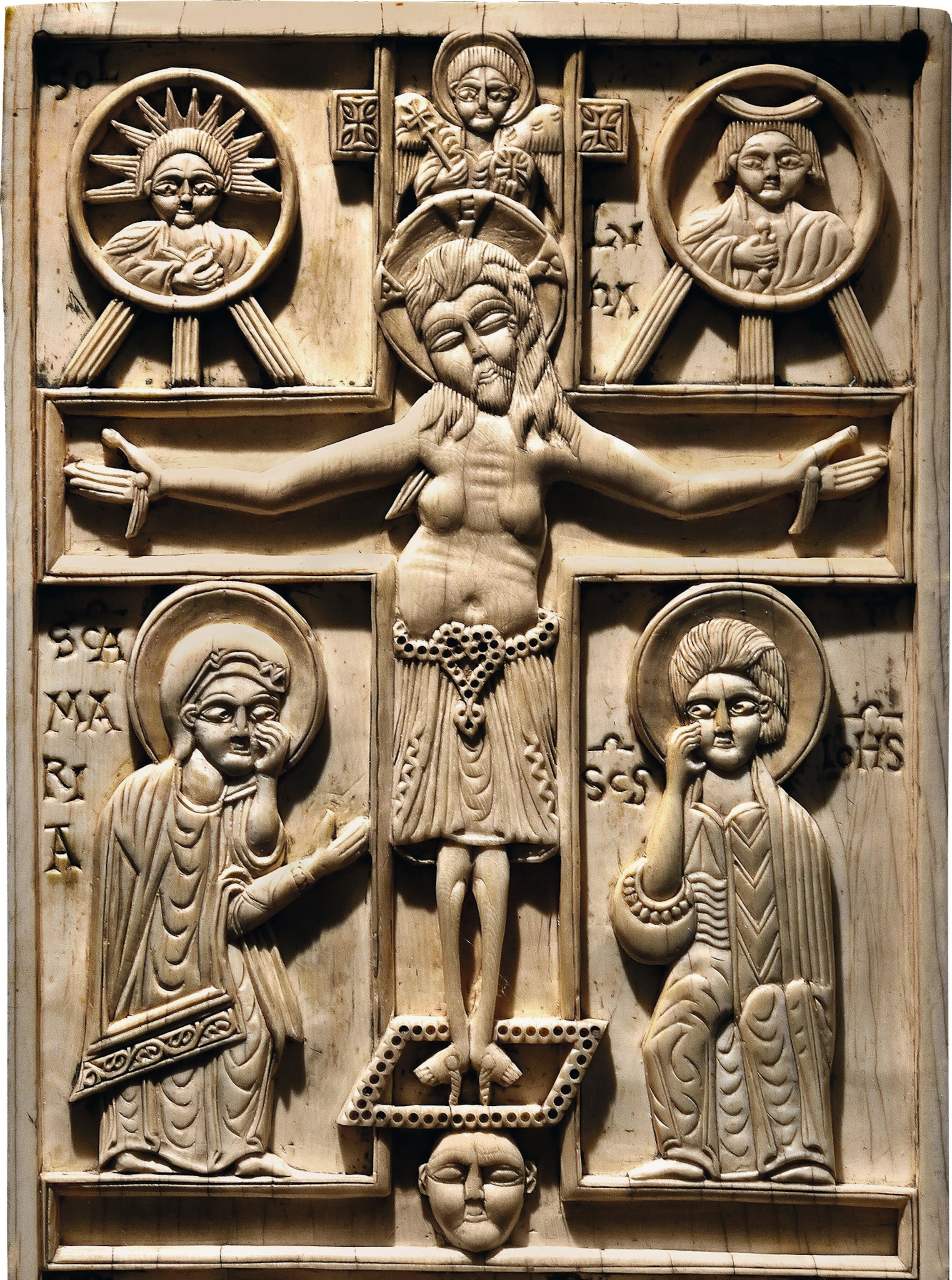 An ivory plaque depicting Christ crucified, with Mary and the apostle John at his feet.