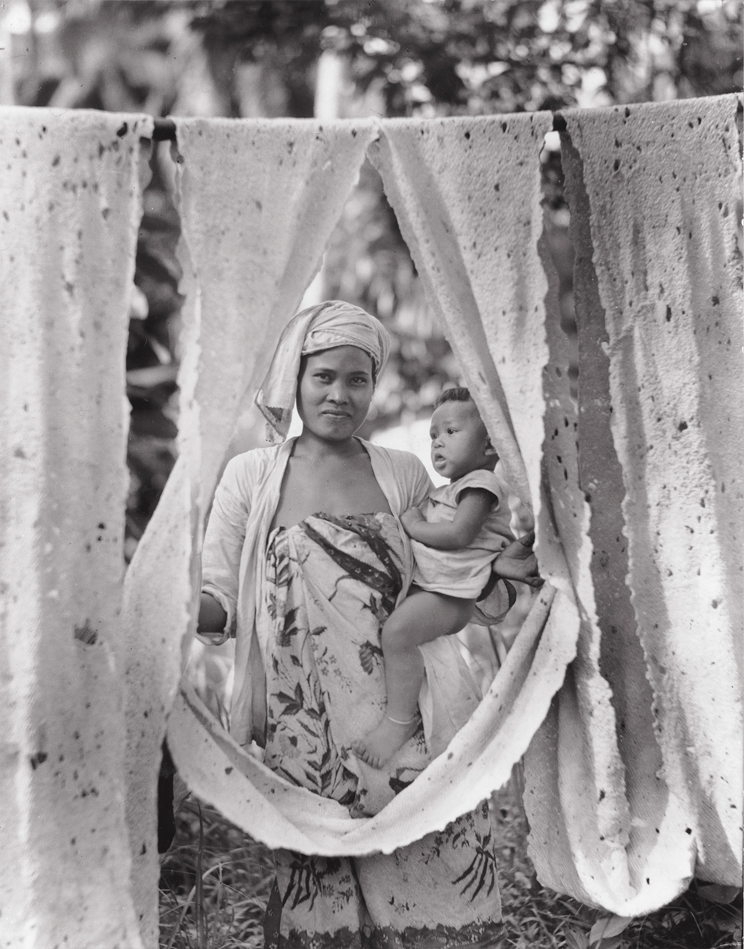 a woman holding sheets of rubber