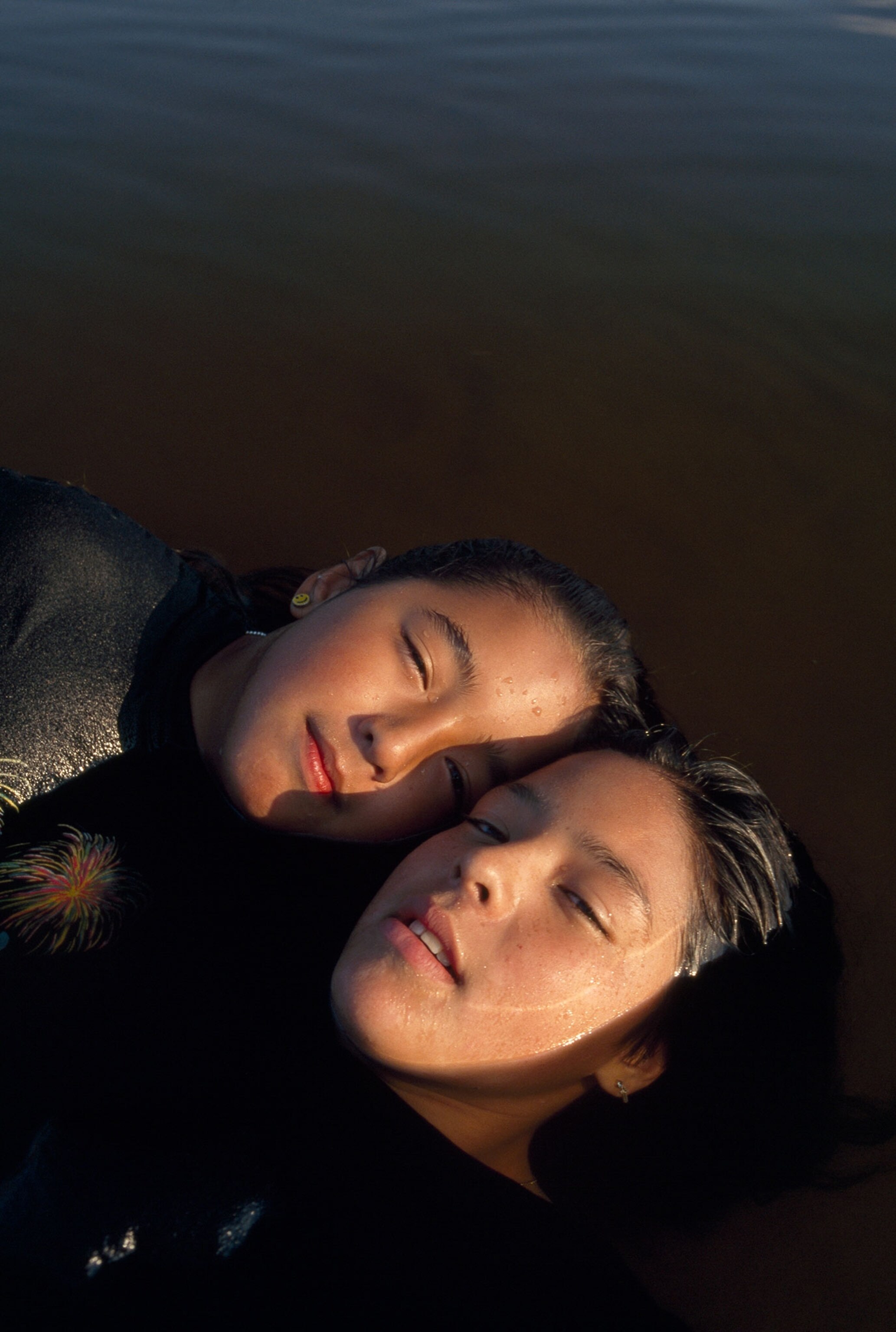 two girls cooling off in a lake together