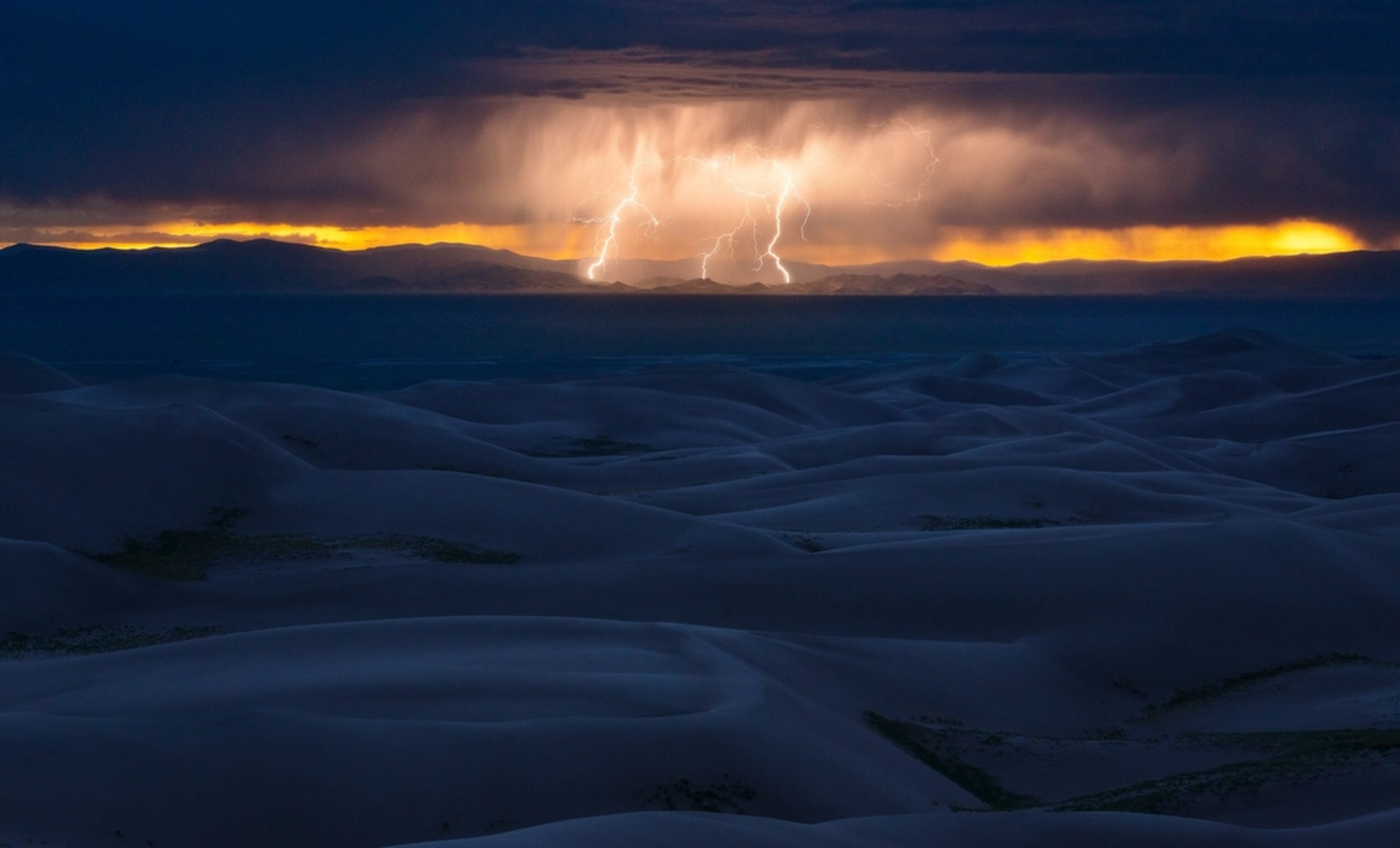 lightning above sand dunes in Hooper, Colorado