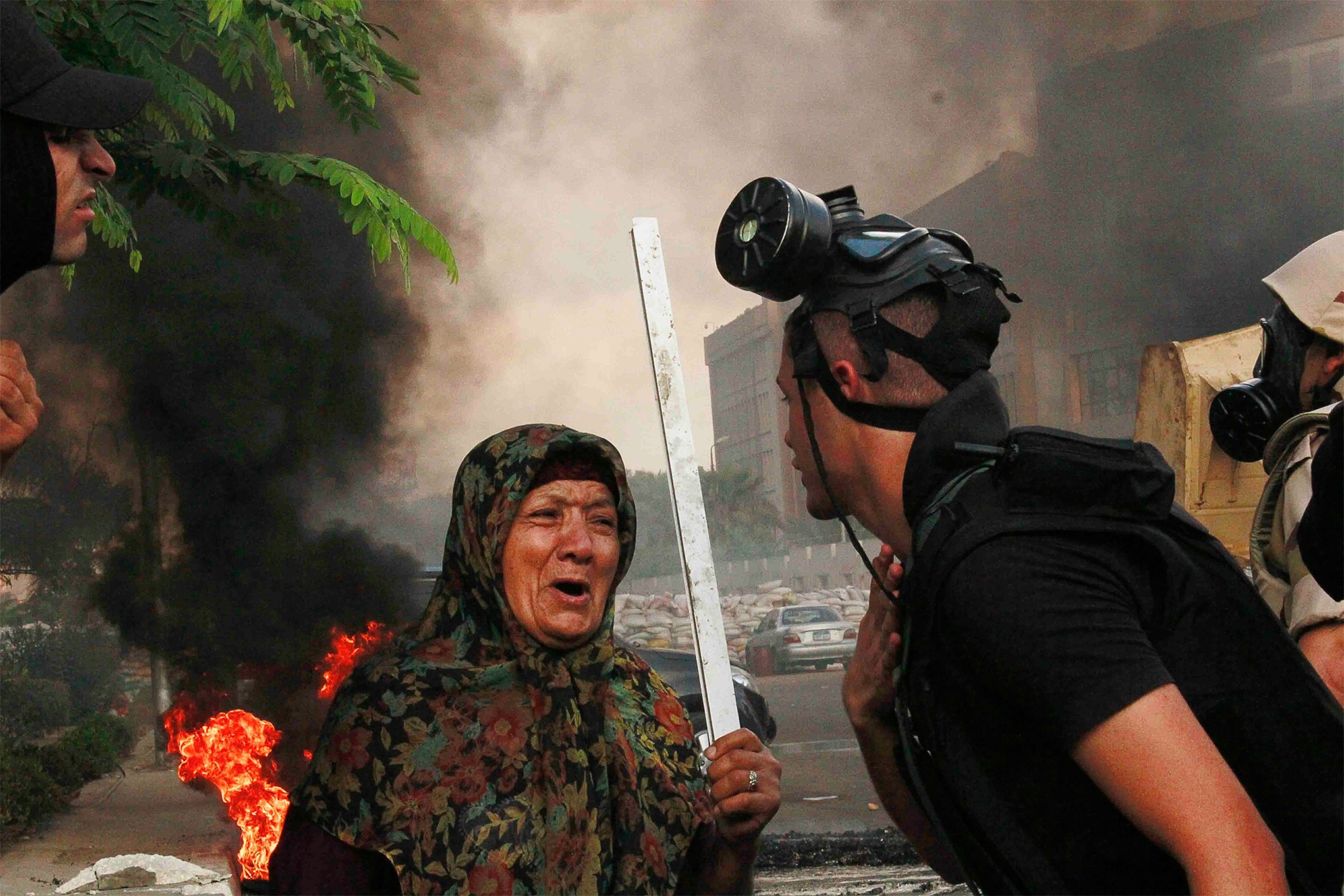 An Egyptian woman with a stick at a protest.