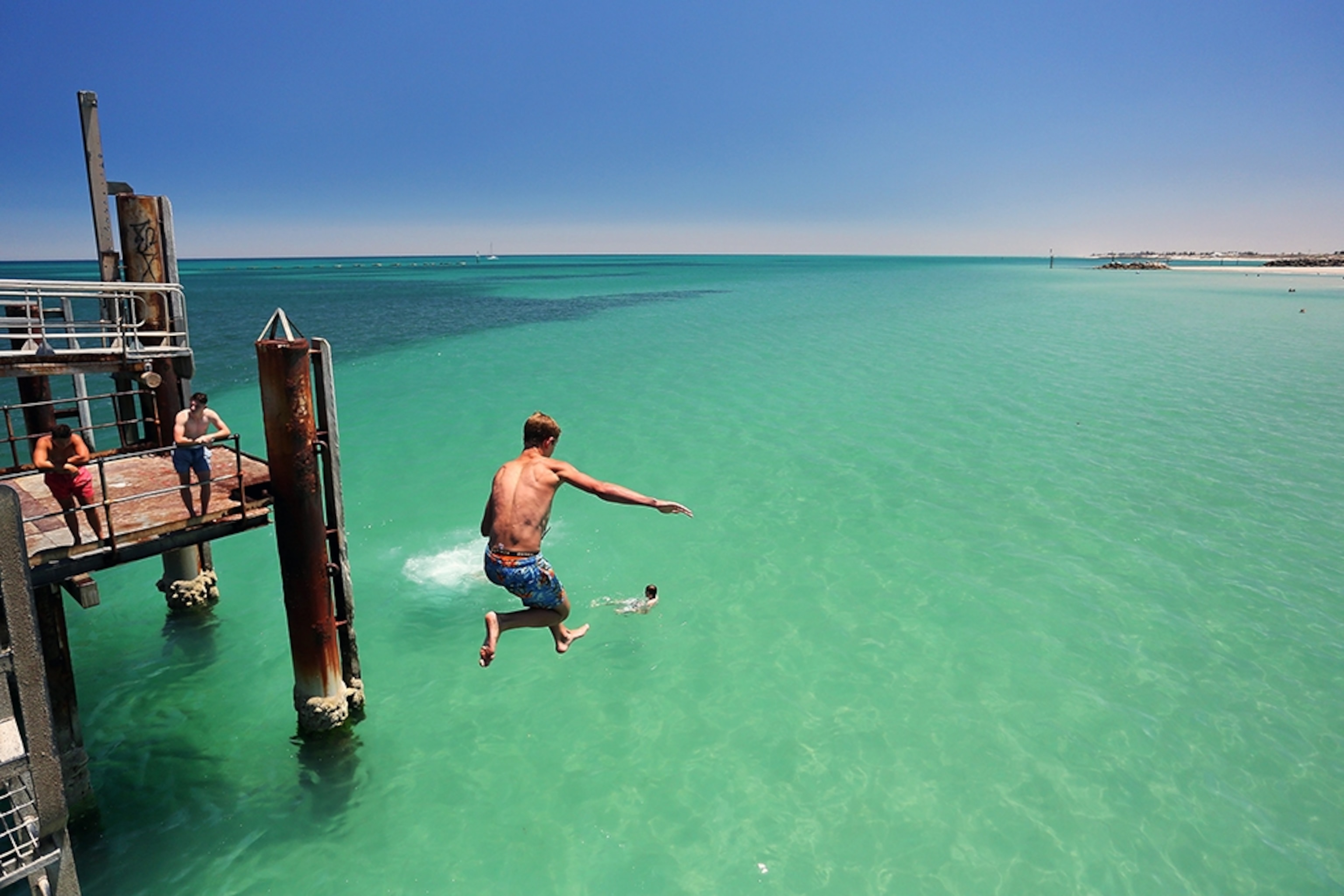a man jumping off Glenelg jetty, Glenelg Beach, Australia
