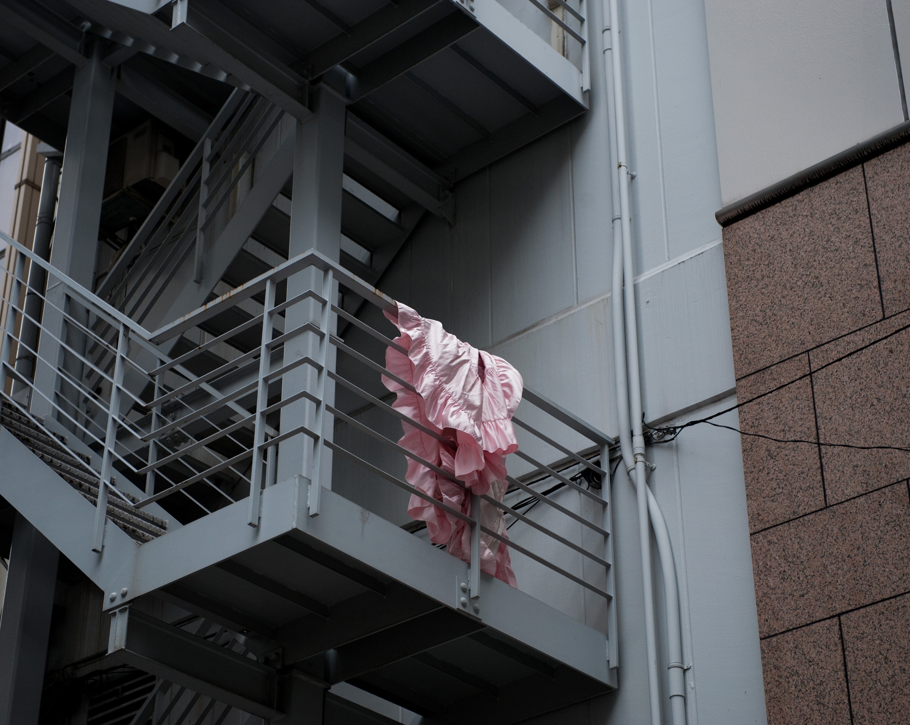 a blanket on an emergency exit of a building in the Love Hotel district in Tokyo, Japan