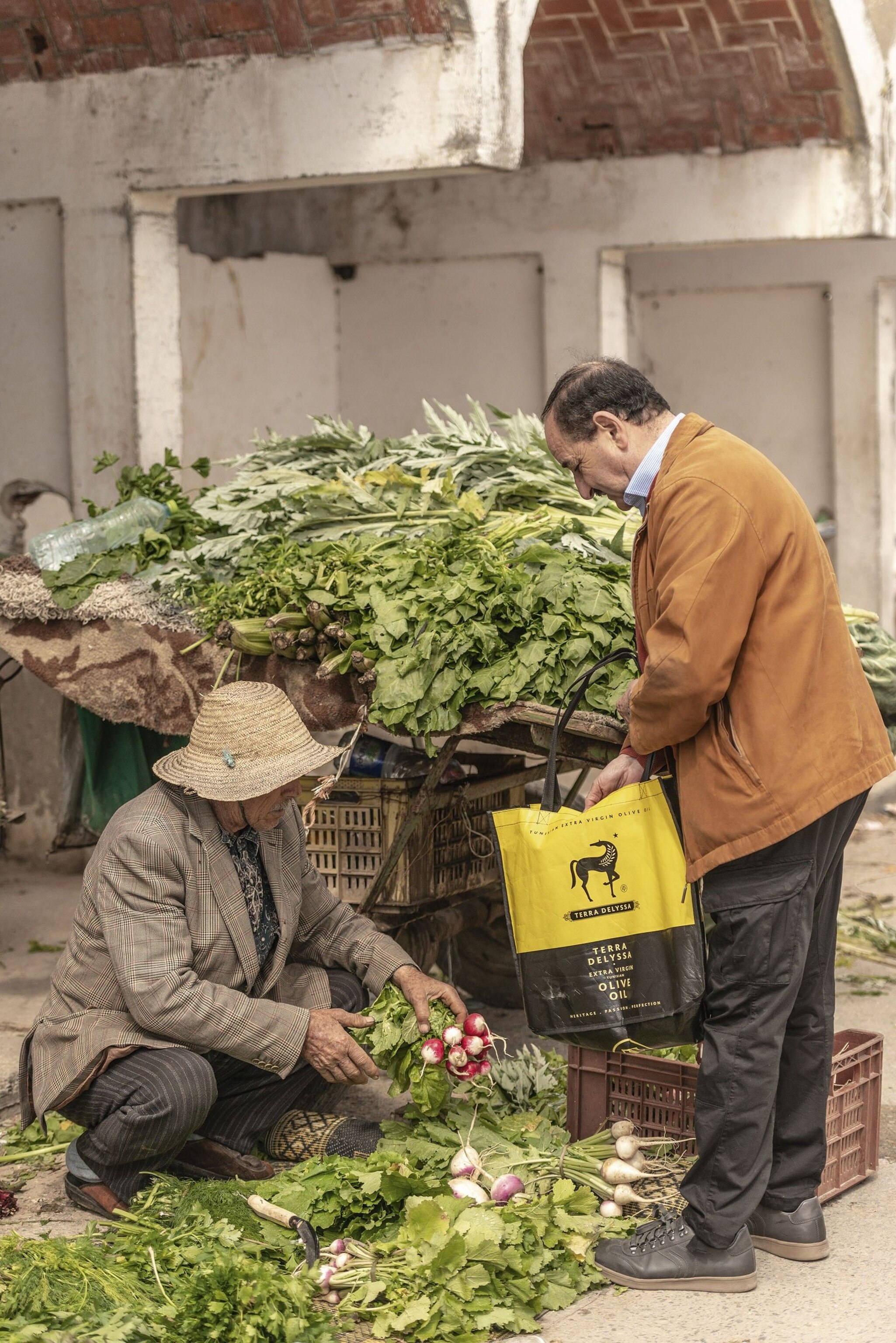 Rafik buying radishes at the market.
