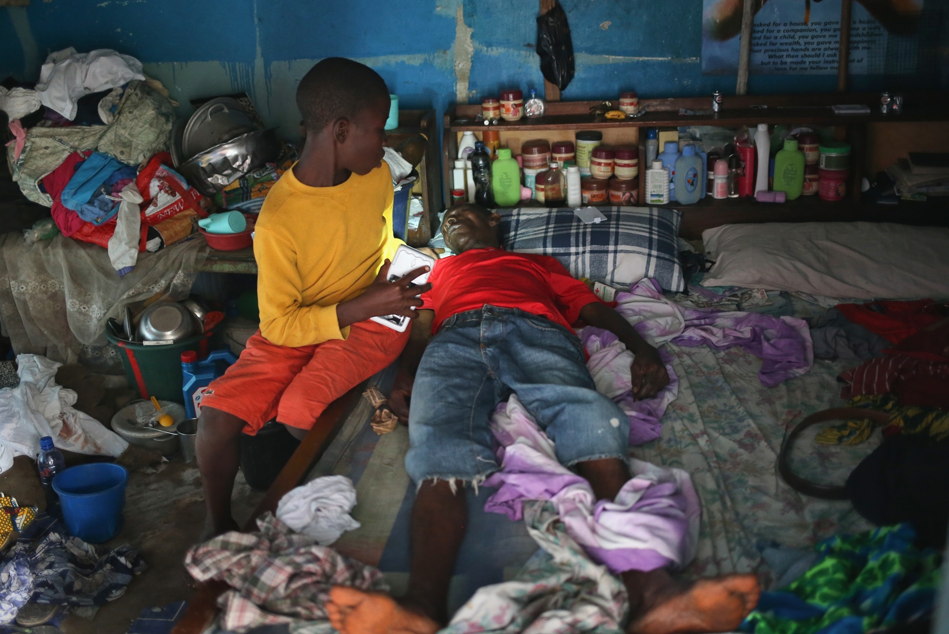 a Liberian health worker disinfecting a corpse after the man died.