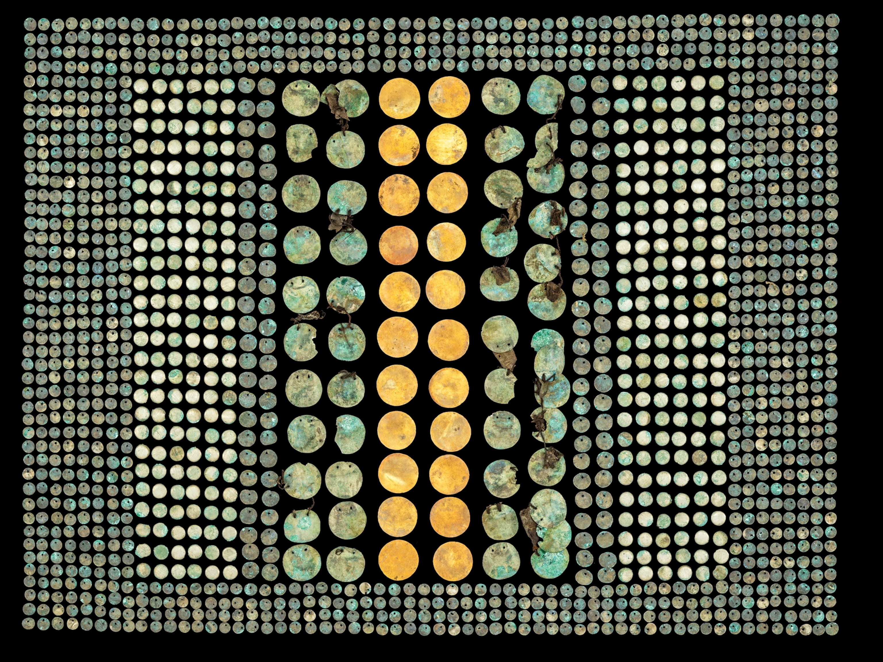 Gold and silver disks organized into geometric patterns.