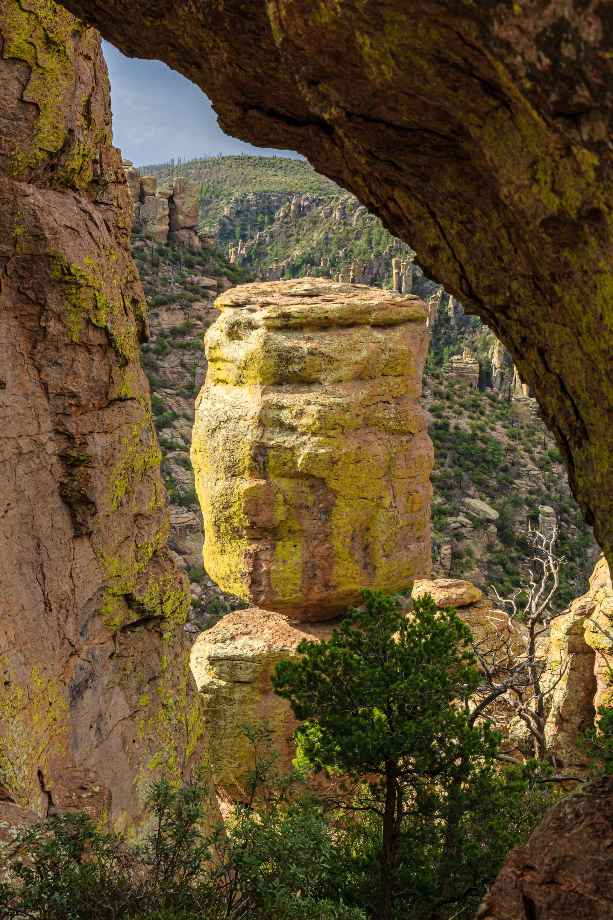 A large stone formation is framed by the edges of two rock walls