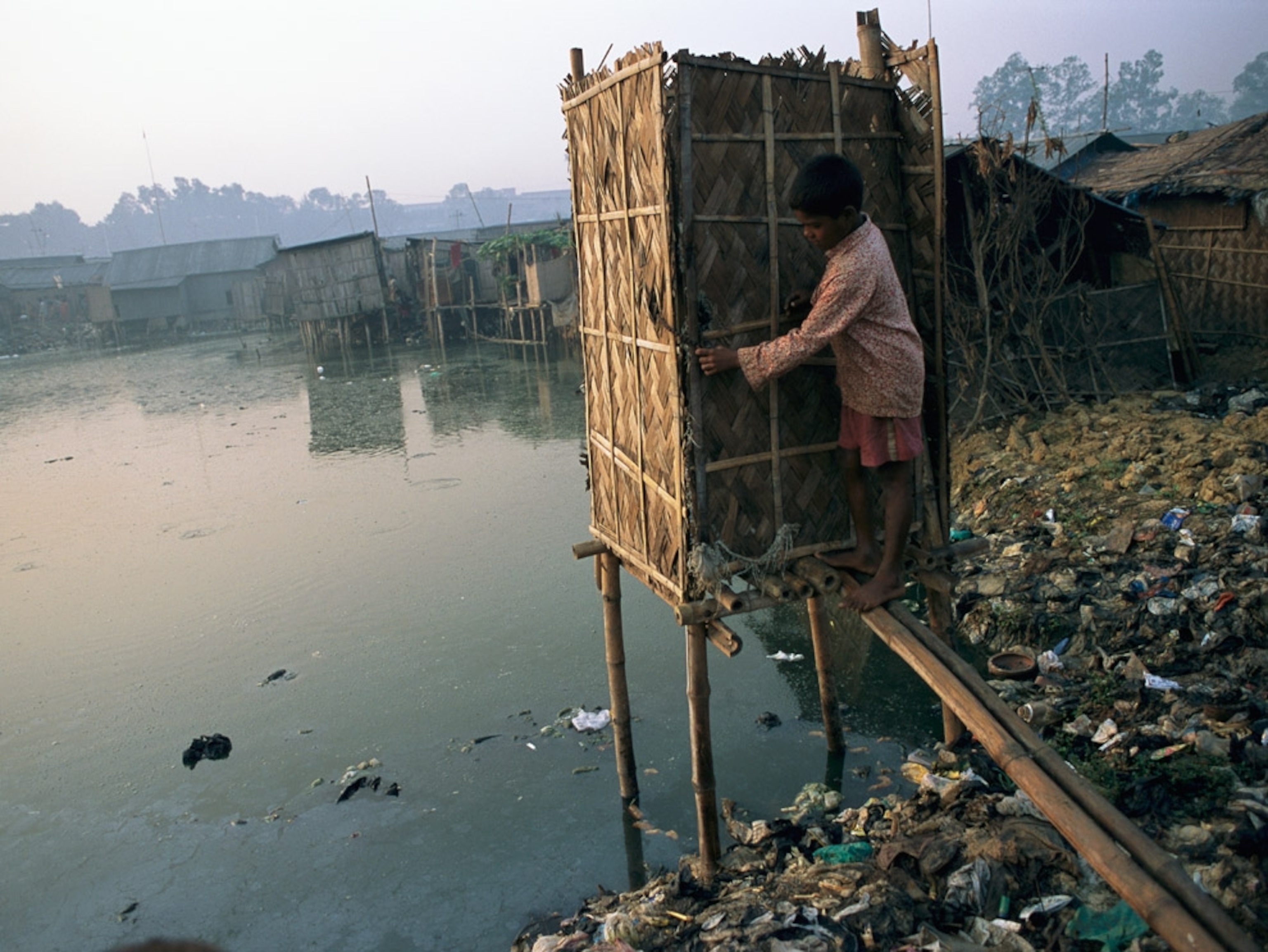 Boy entering outhouse