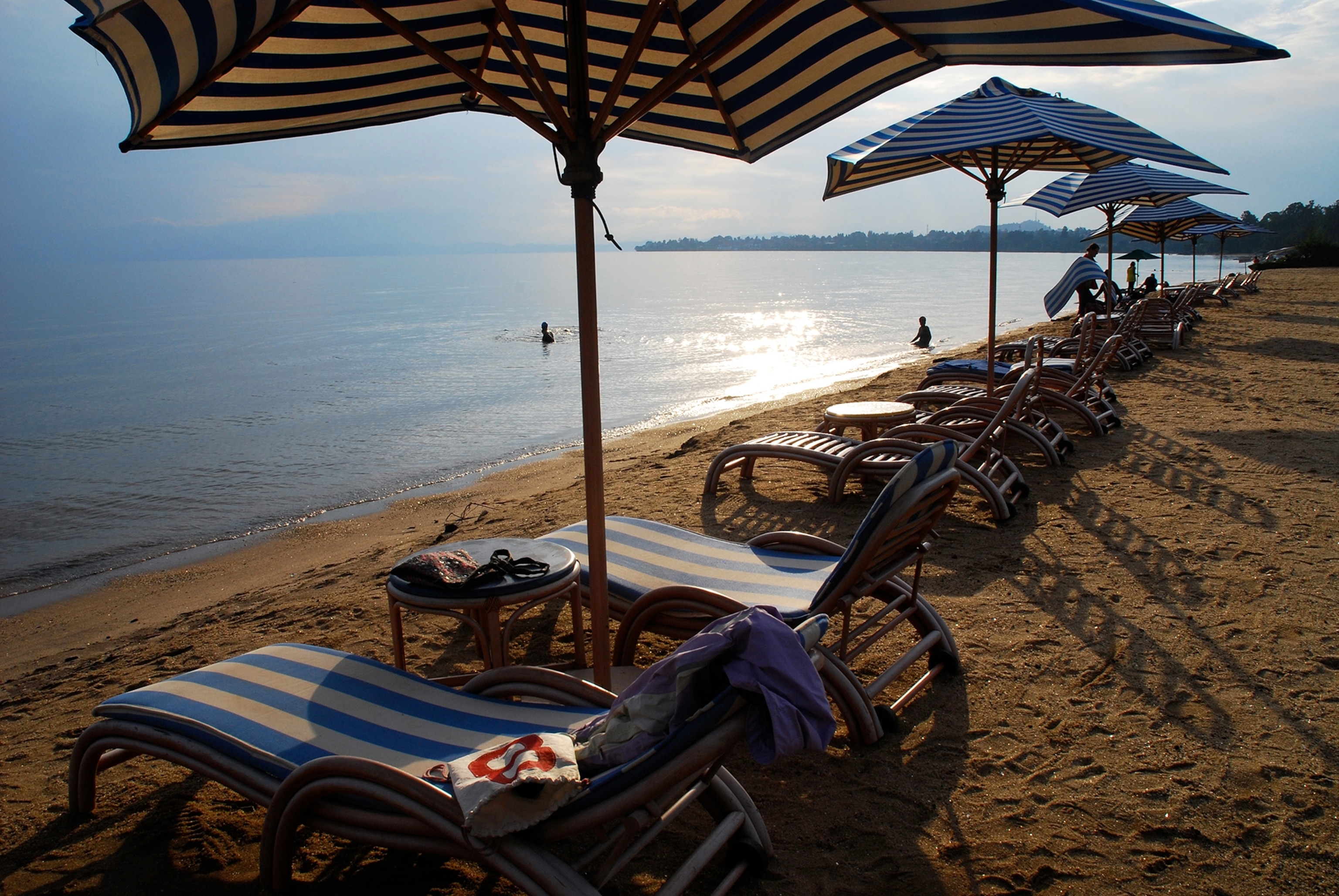 Lounge chairs on the beach at a Lake Kivu resort.