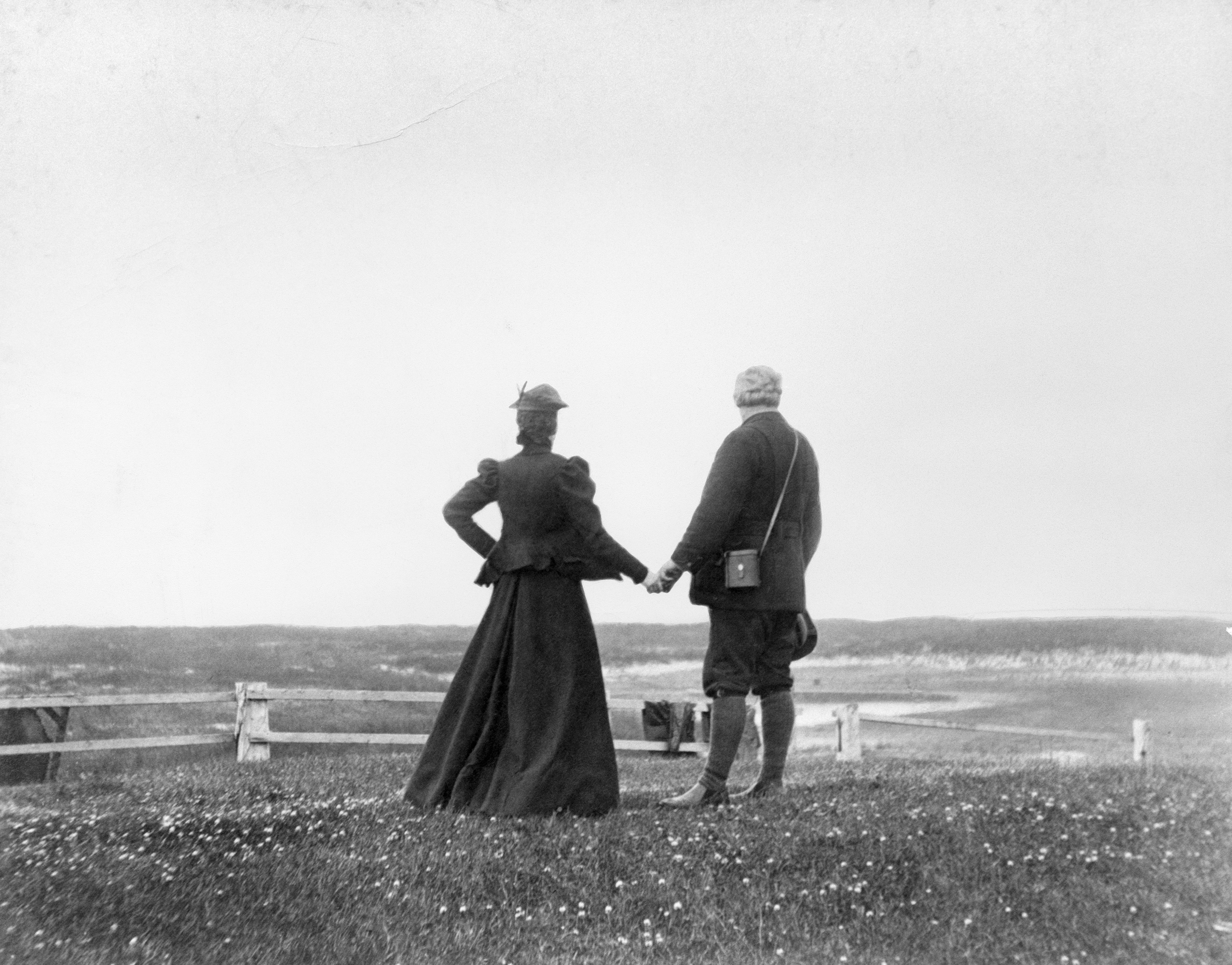 Alexander Graham Bell and his wife, Mabel, hold hands at the water's edge at Sable Island.