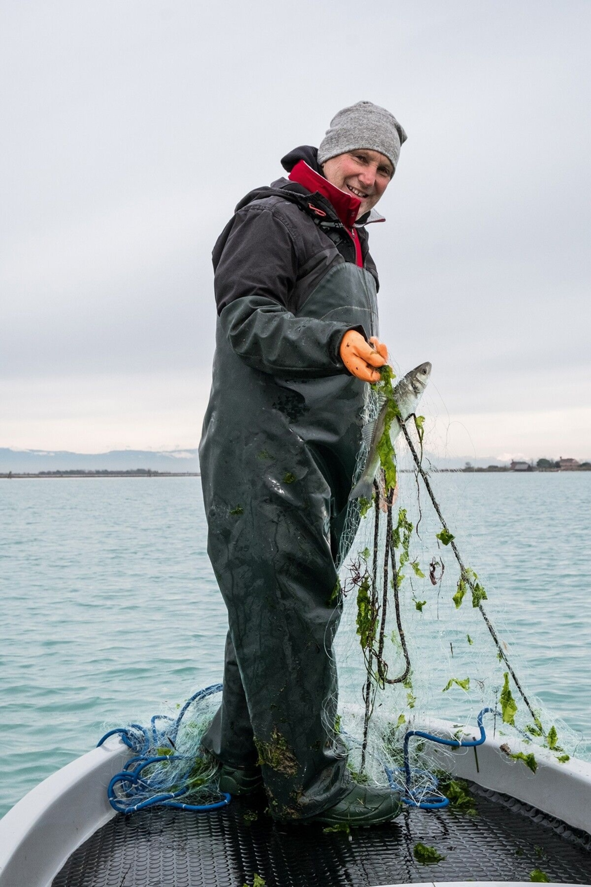Fisherman Andrea Rossi at work with his nets in the lagoon