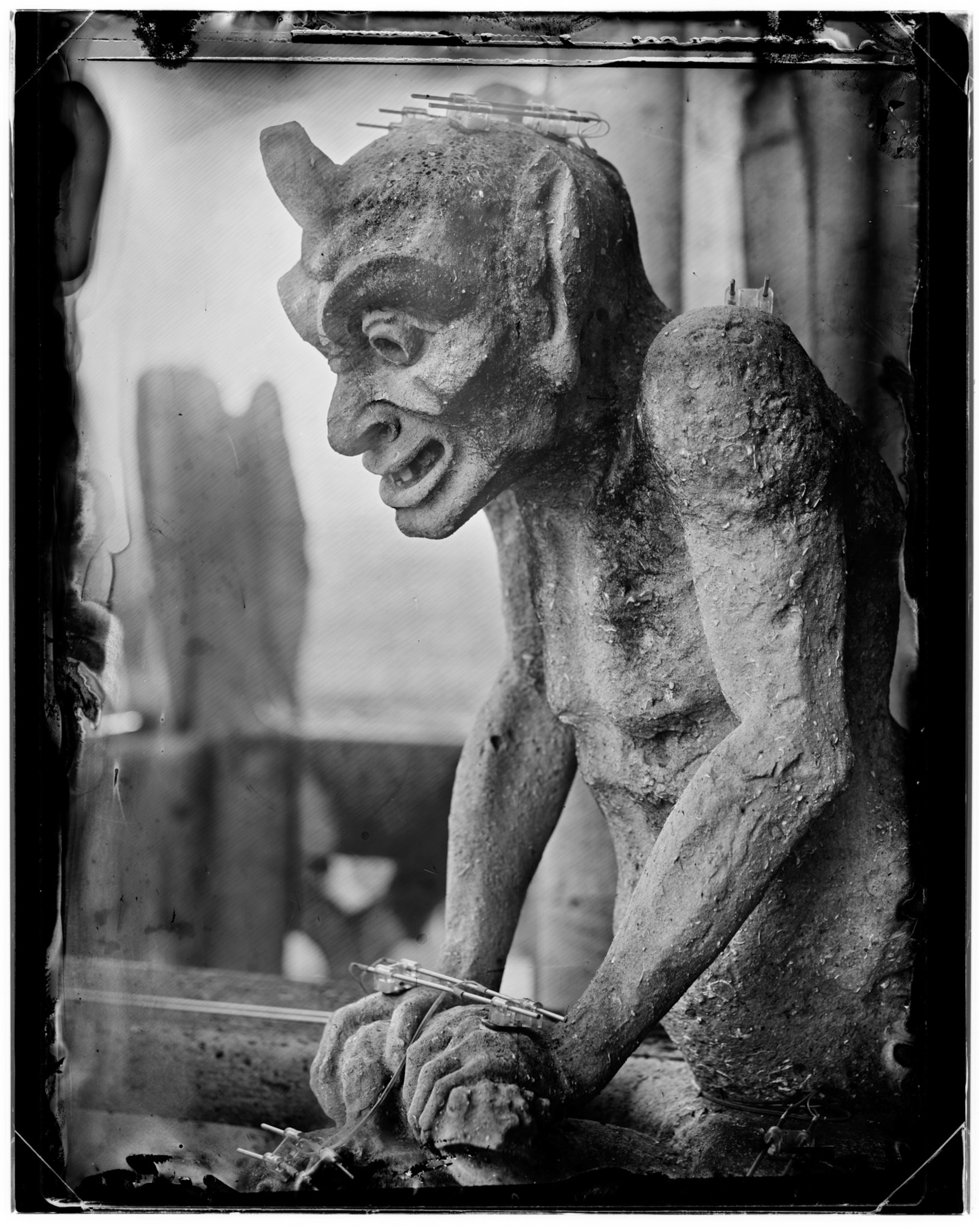 Gargoyle sits on Notre Dame cathedral