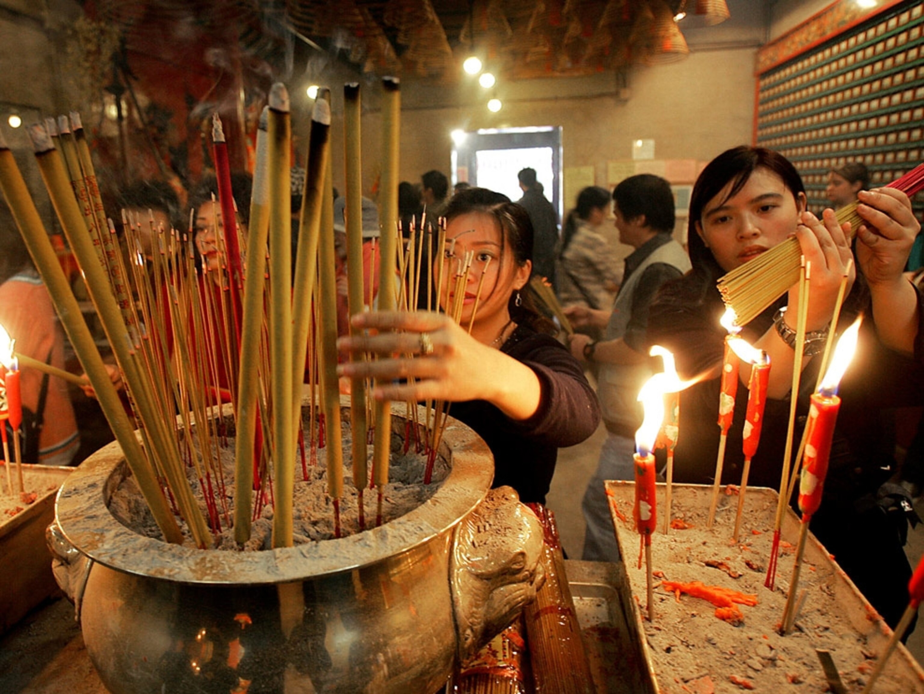 People light incense in a temple