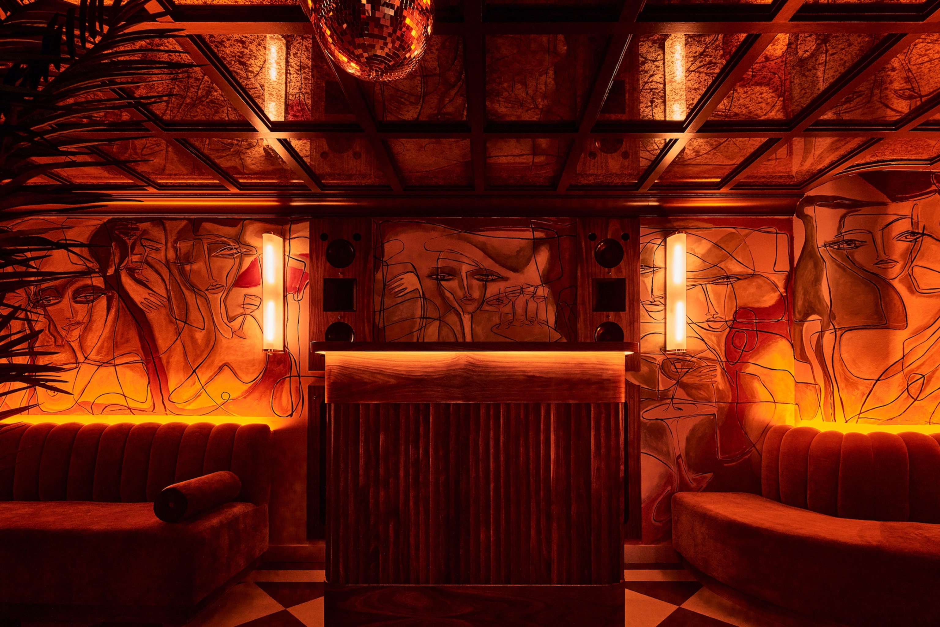The interior of a moody seating area with painted walls.