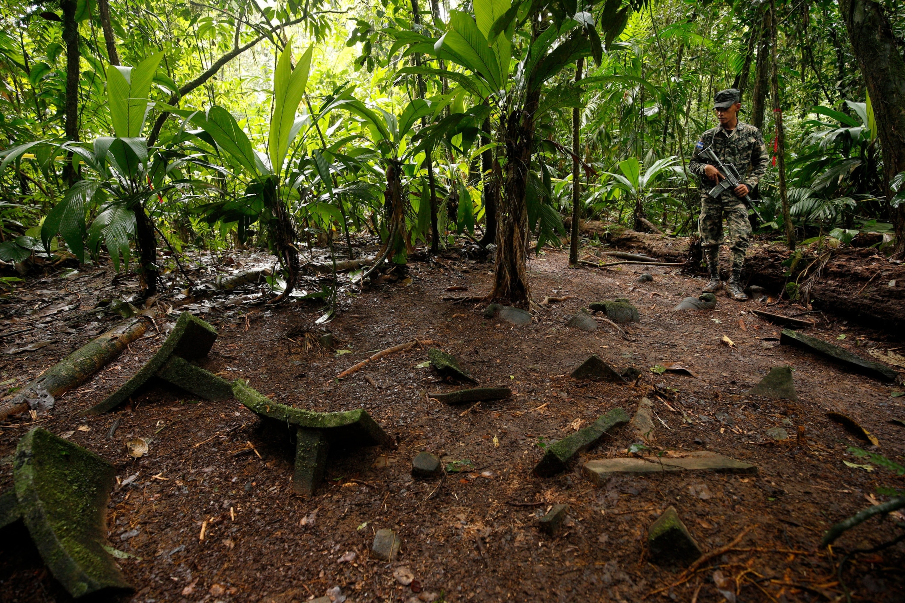 armed guard watching over artifacts in jungle in Honduras