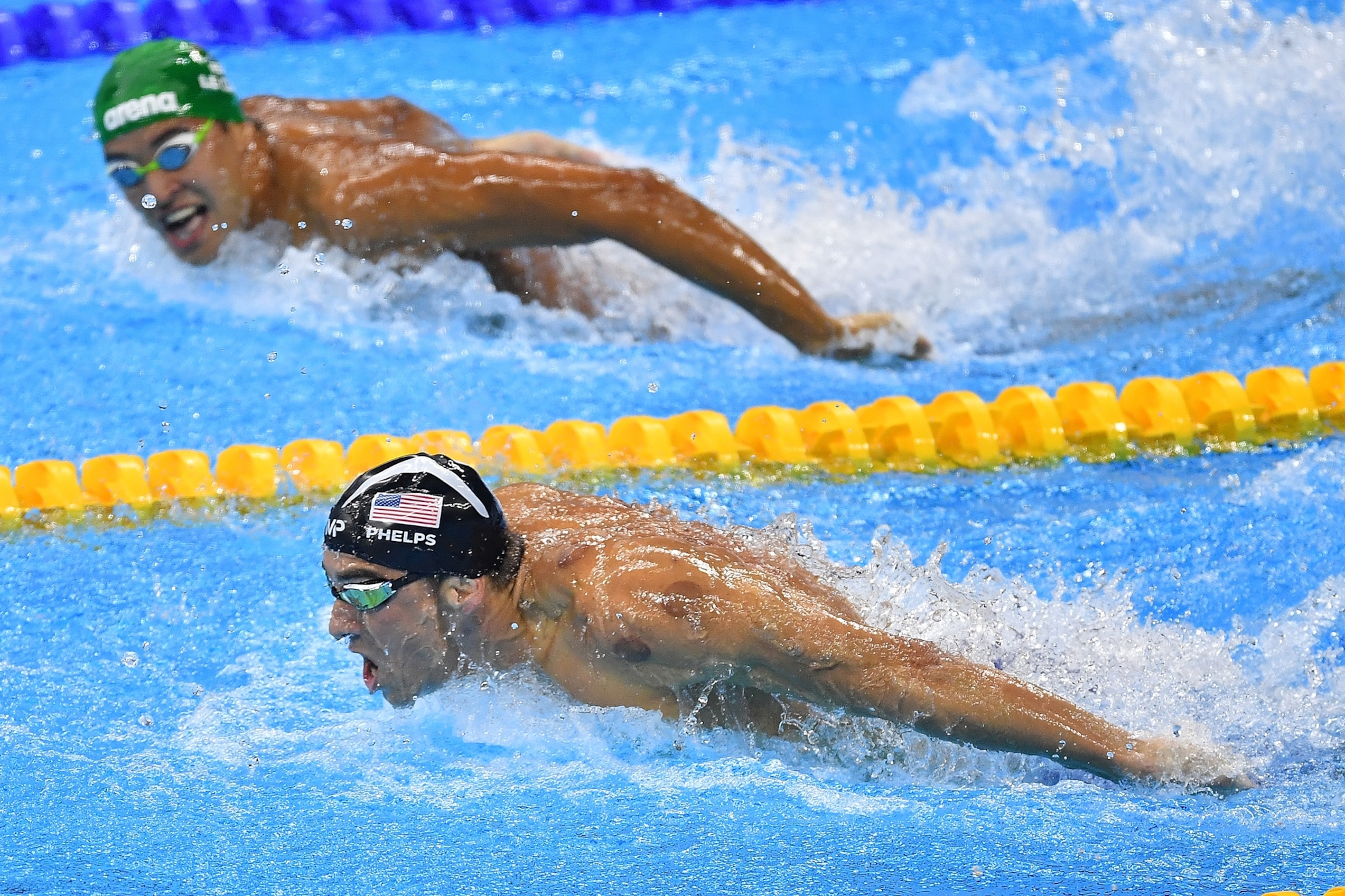 Two men swim in between competitive lanes.