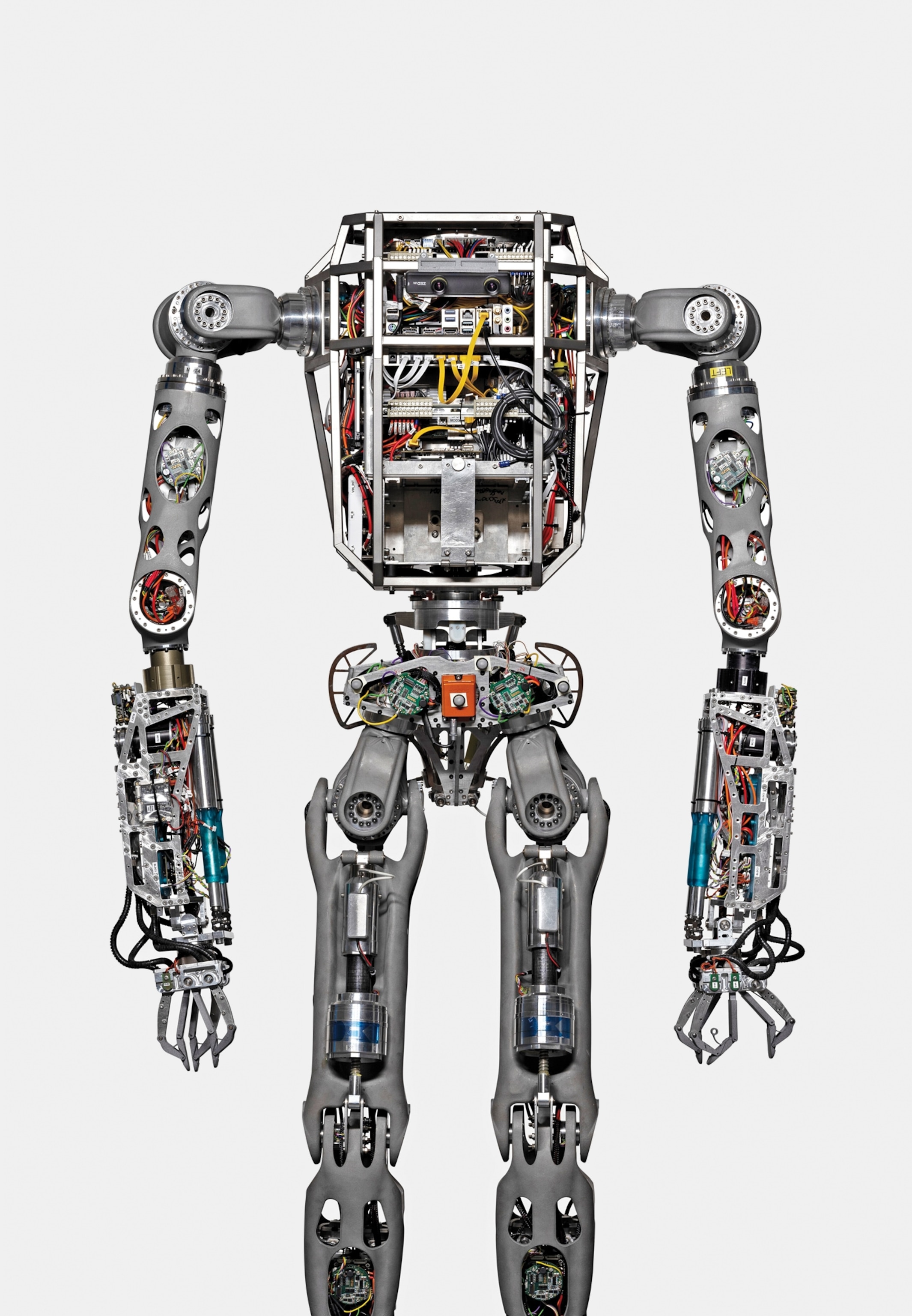 A humanoid robot with exposed metallic framework, intricate wiring, and mechanical joints.
