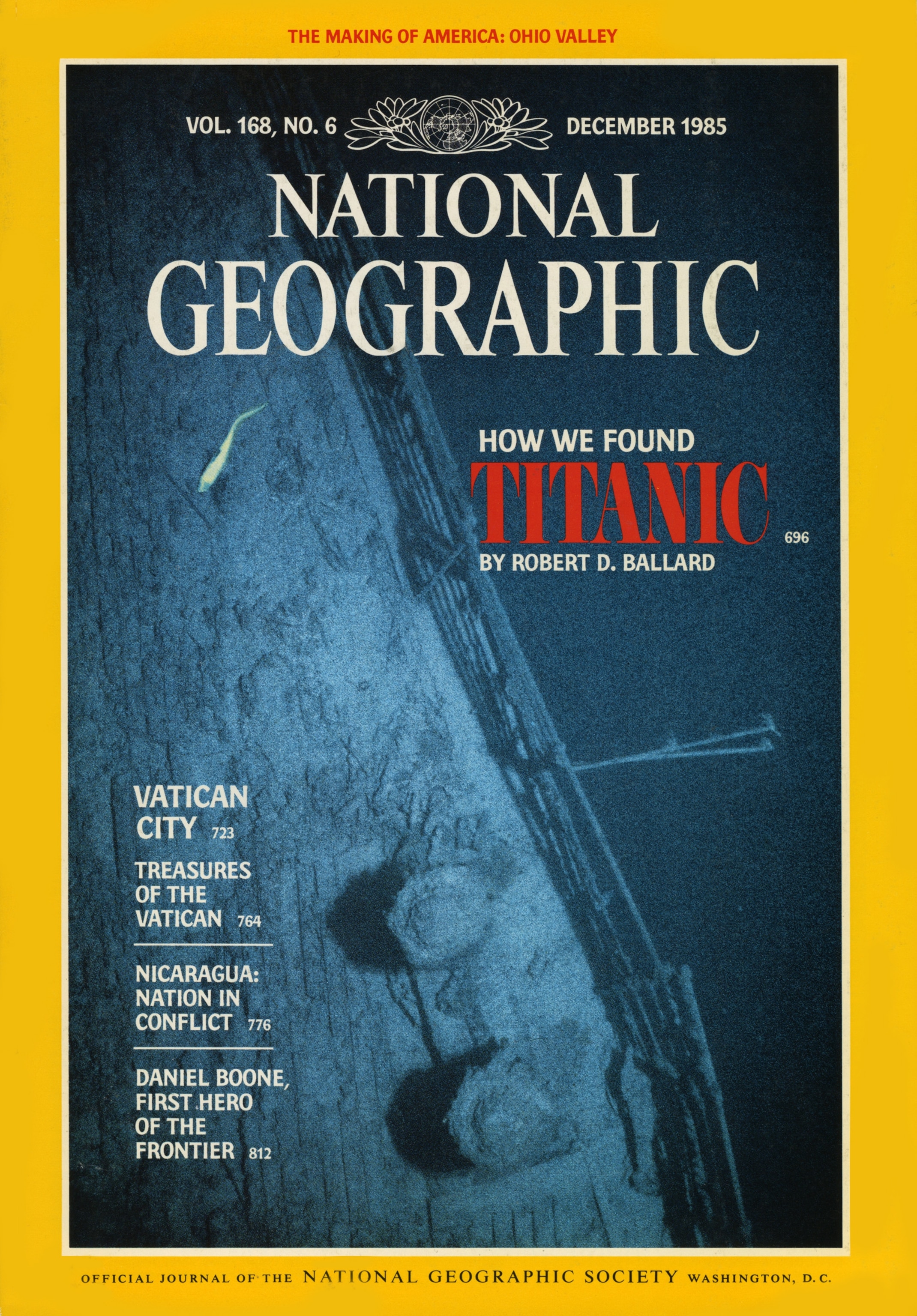 A rattail fish glides in the deep above Titanic’s foredeck, port rail and mooring bitts.