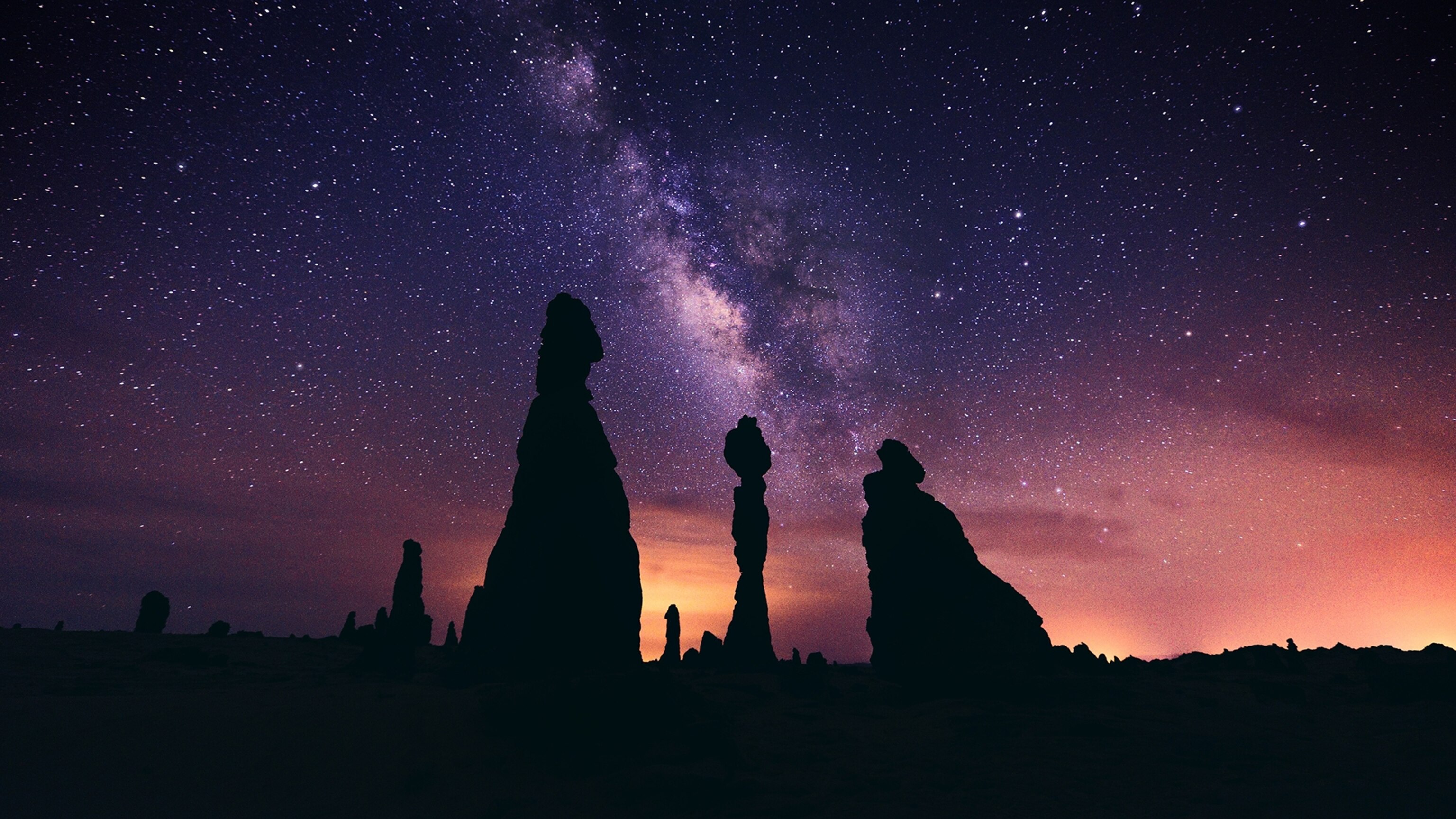 the Milky Way above rocks in the Gharameel Desert in Saudi Arabia