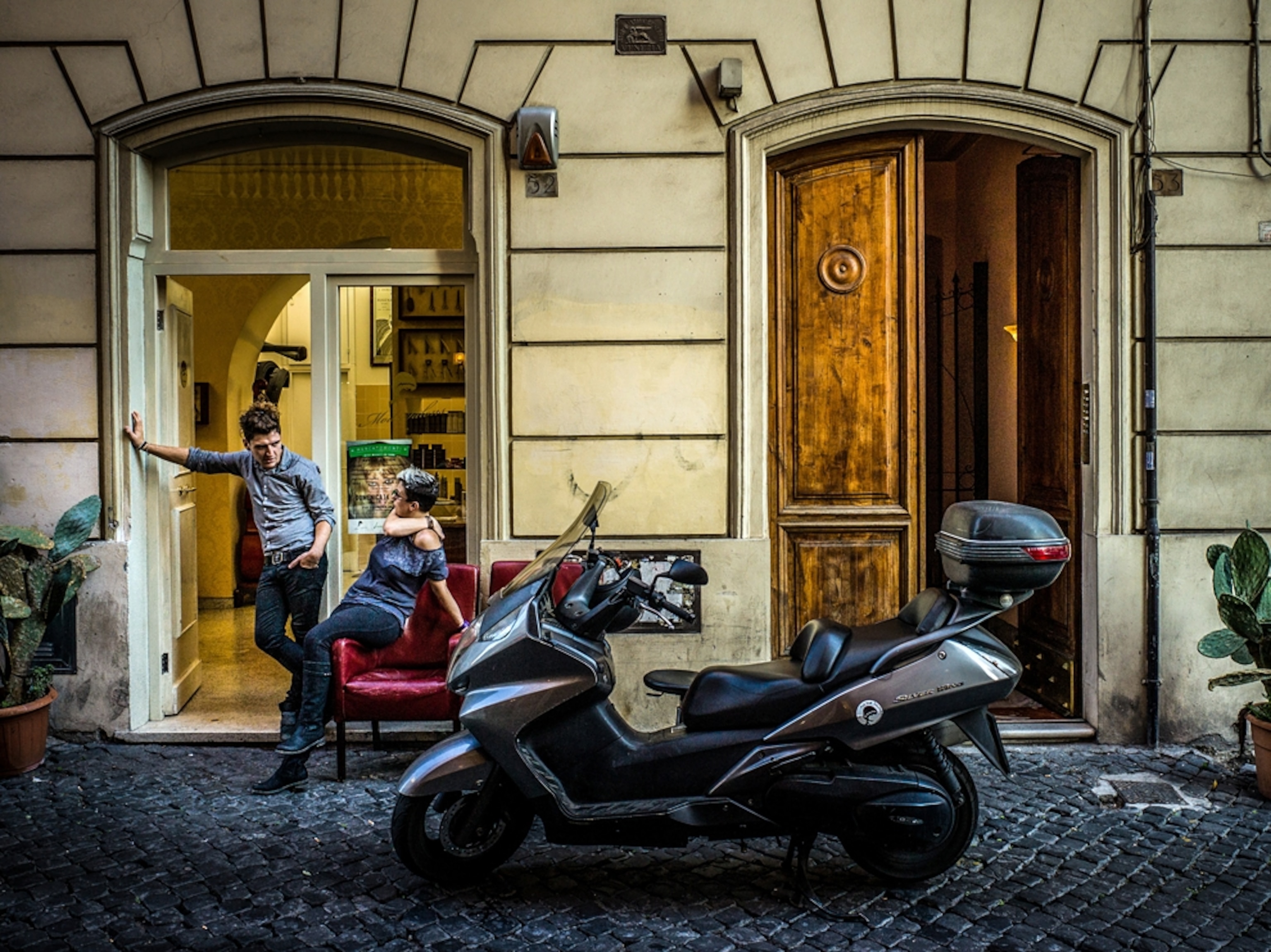 a man and woman outside a shop in Rome, Italy