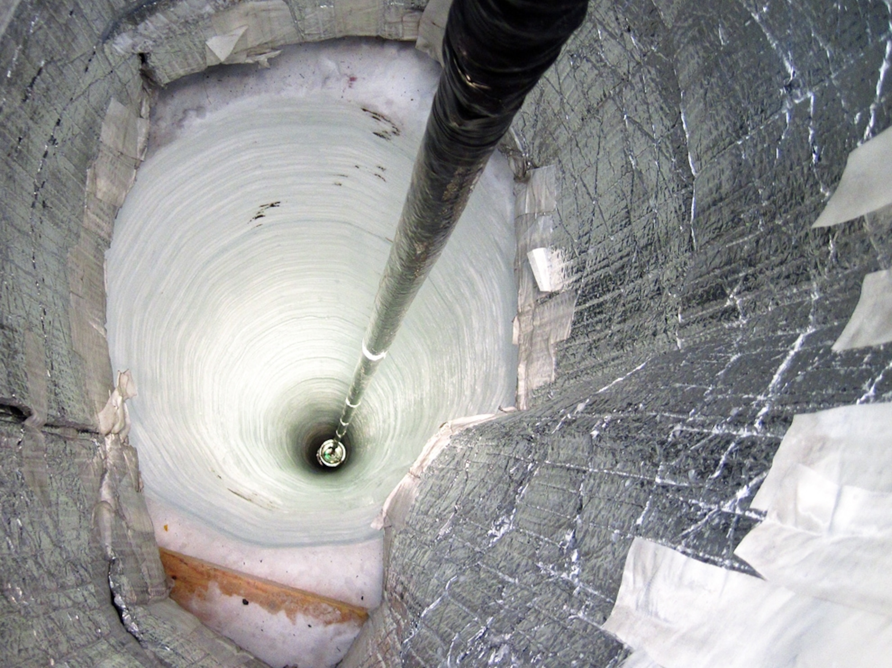 sensor drops into ice hole -- picture from a photo gallery on the IceCube Neutrino Observatory at the South Pole in Antarctica