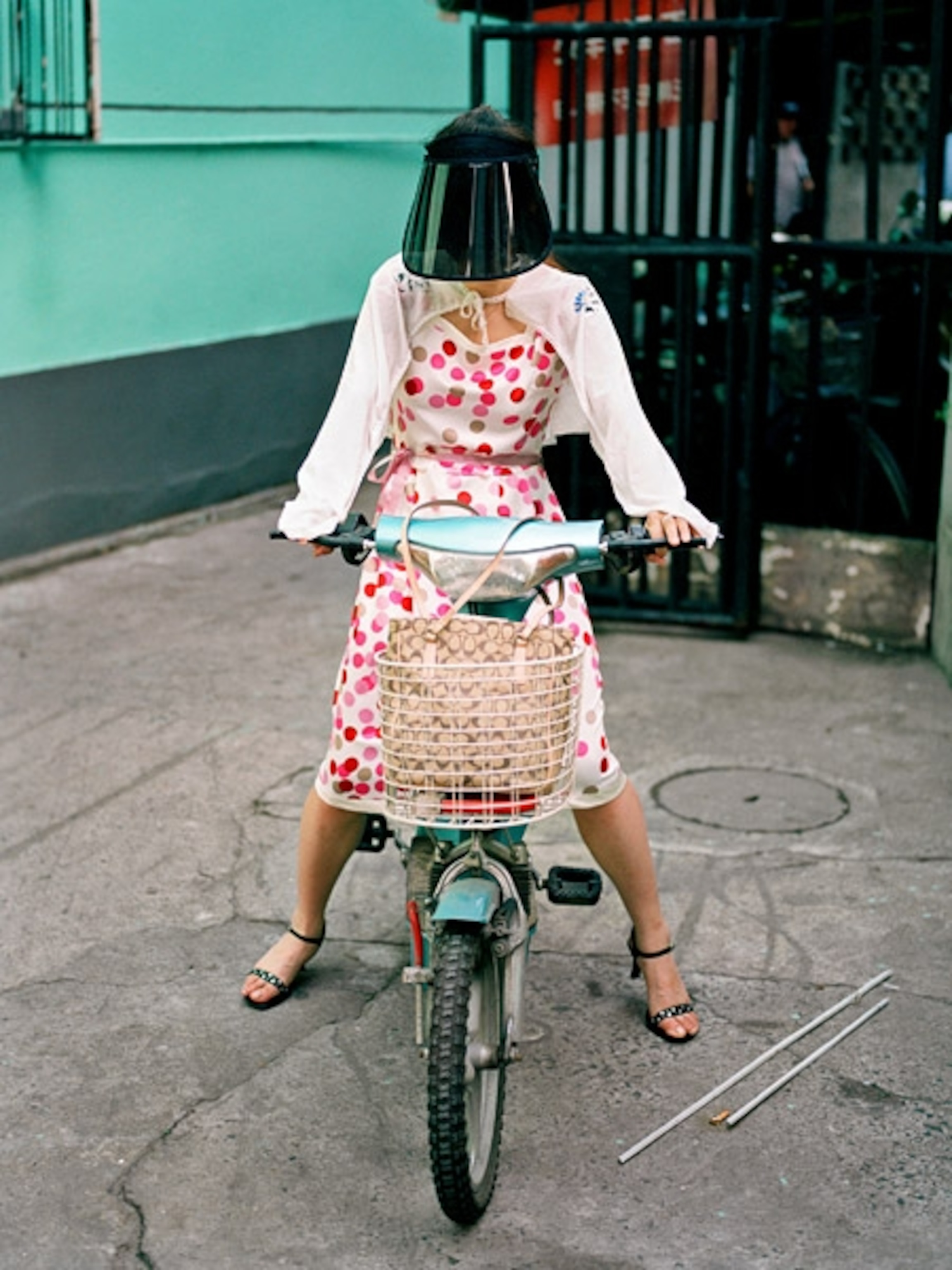 A woman on a bicycle wearing a visor