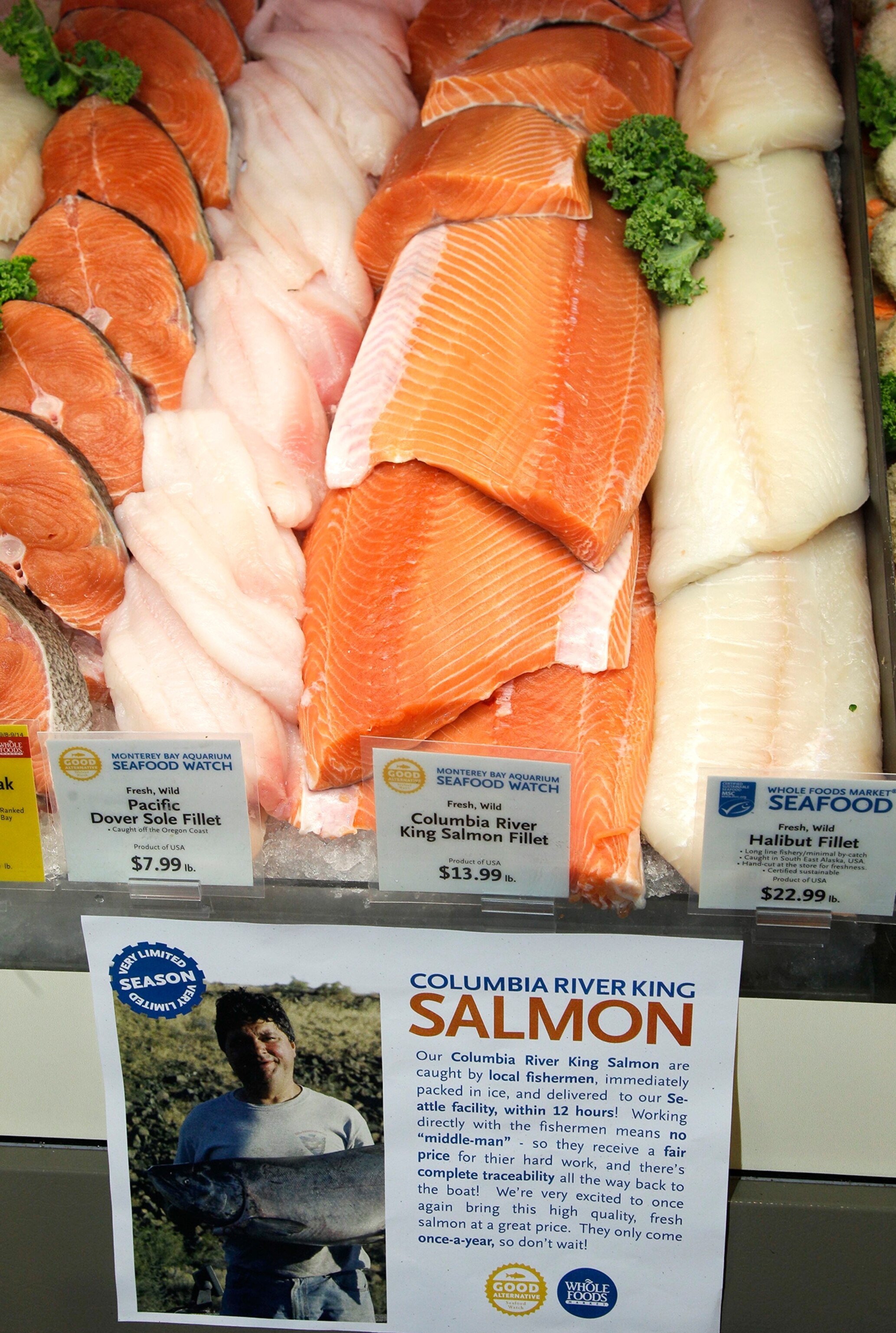 a fishmonger peeling the spine from a tuna.