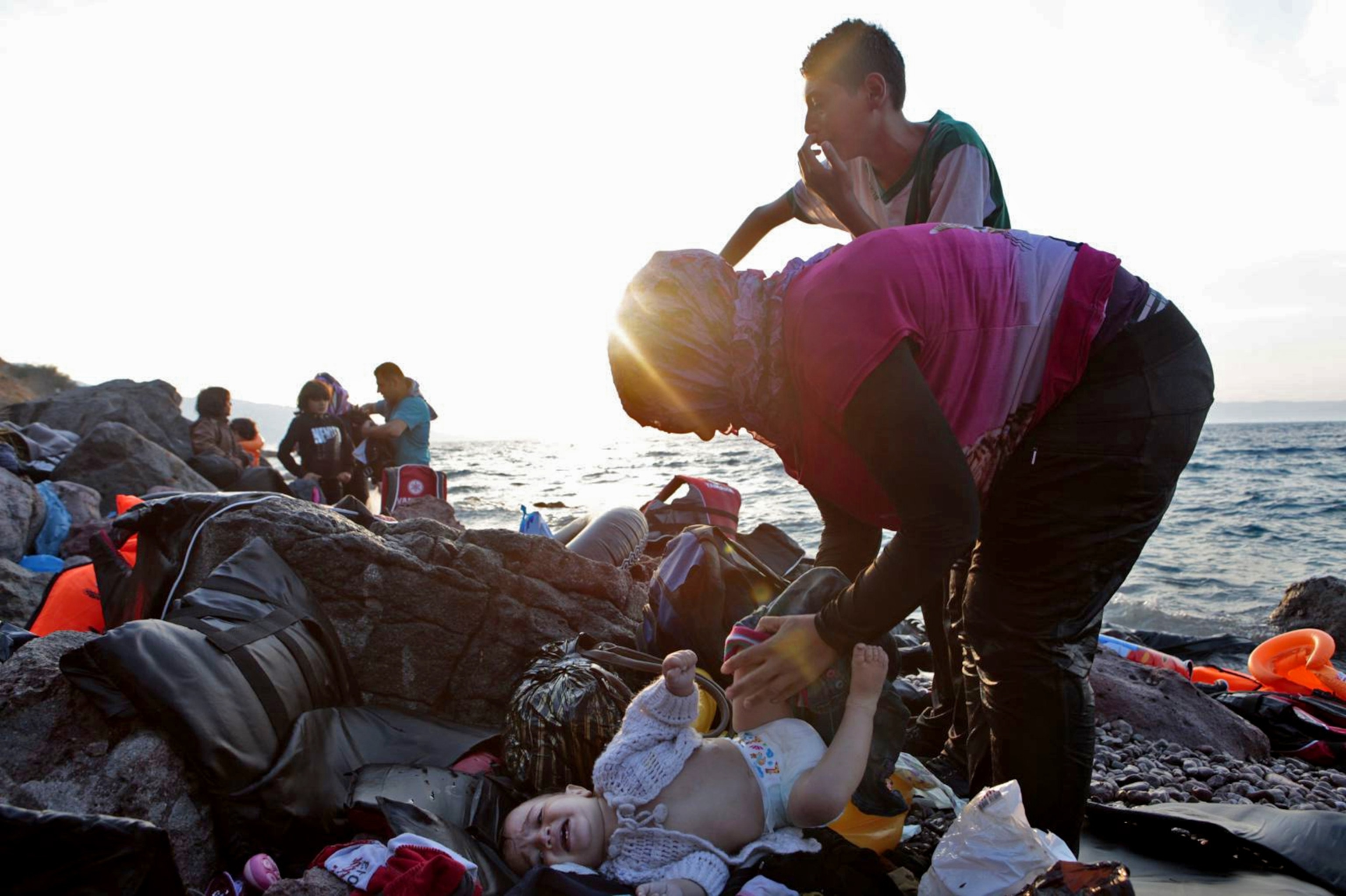 refugee changes her daughter's diaper