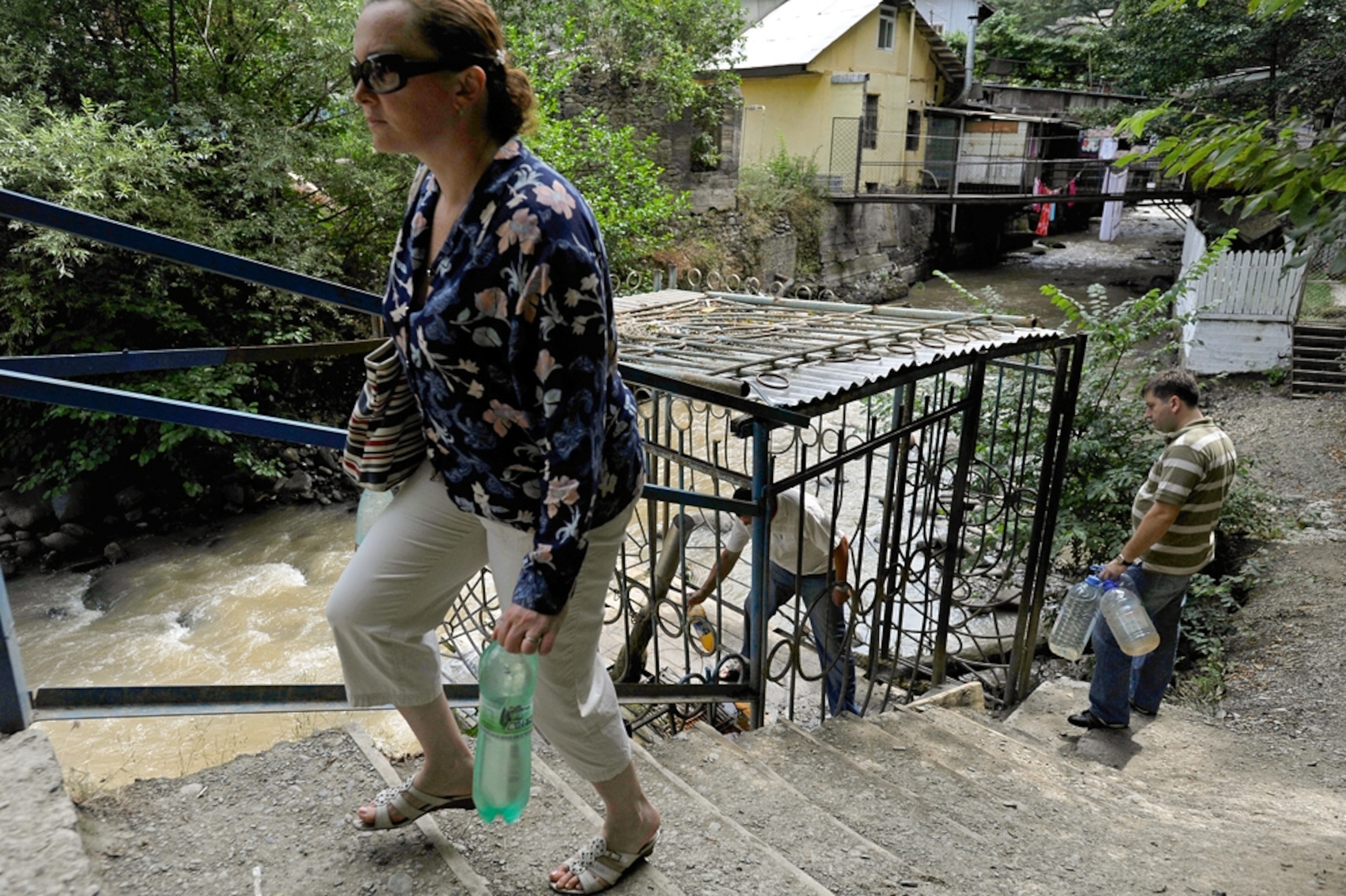 People gather water from a natural spring source in Borjomi, Georgia