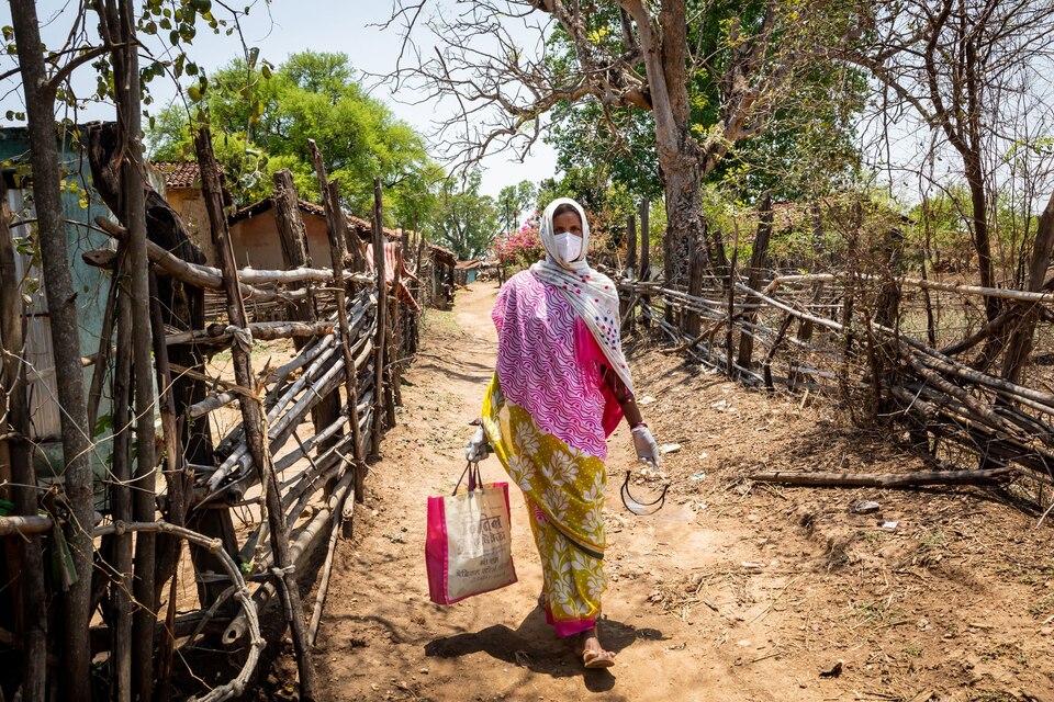 Health worker walks door-to-door in rural India.
