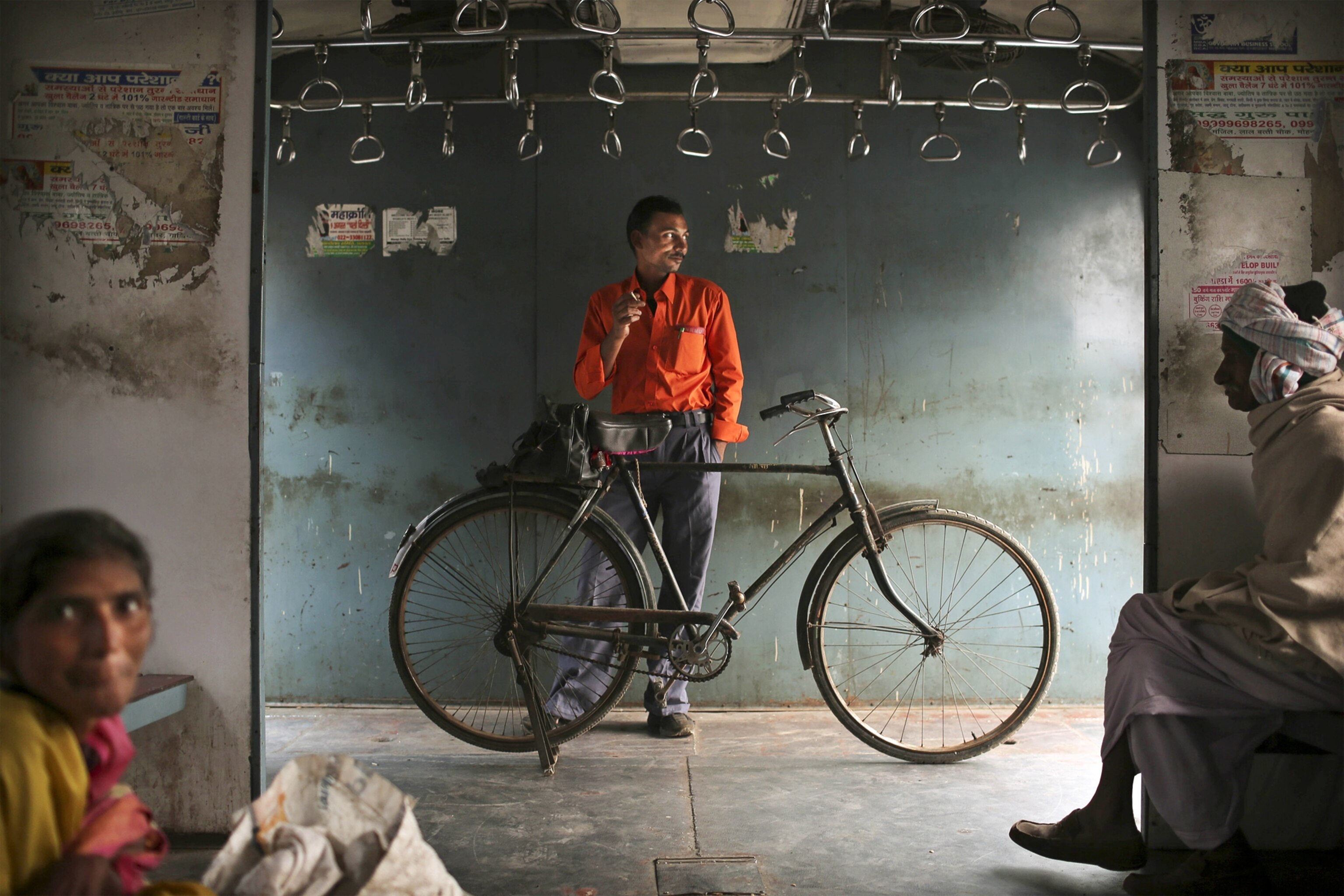 a man with a bike on a train, New Delhi, India