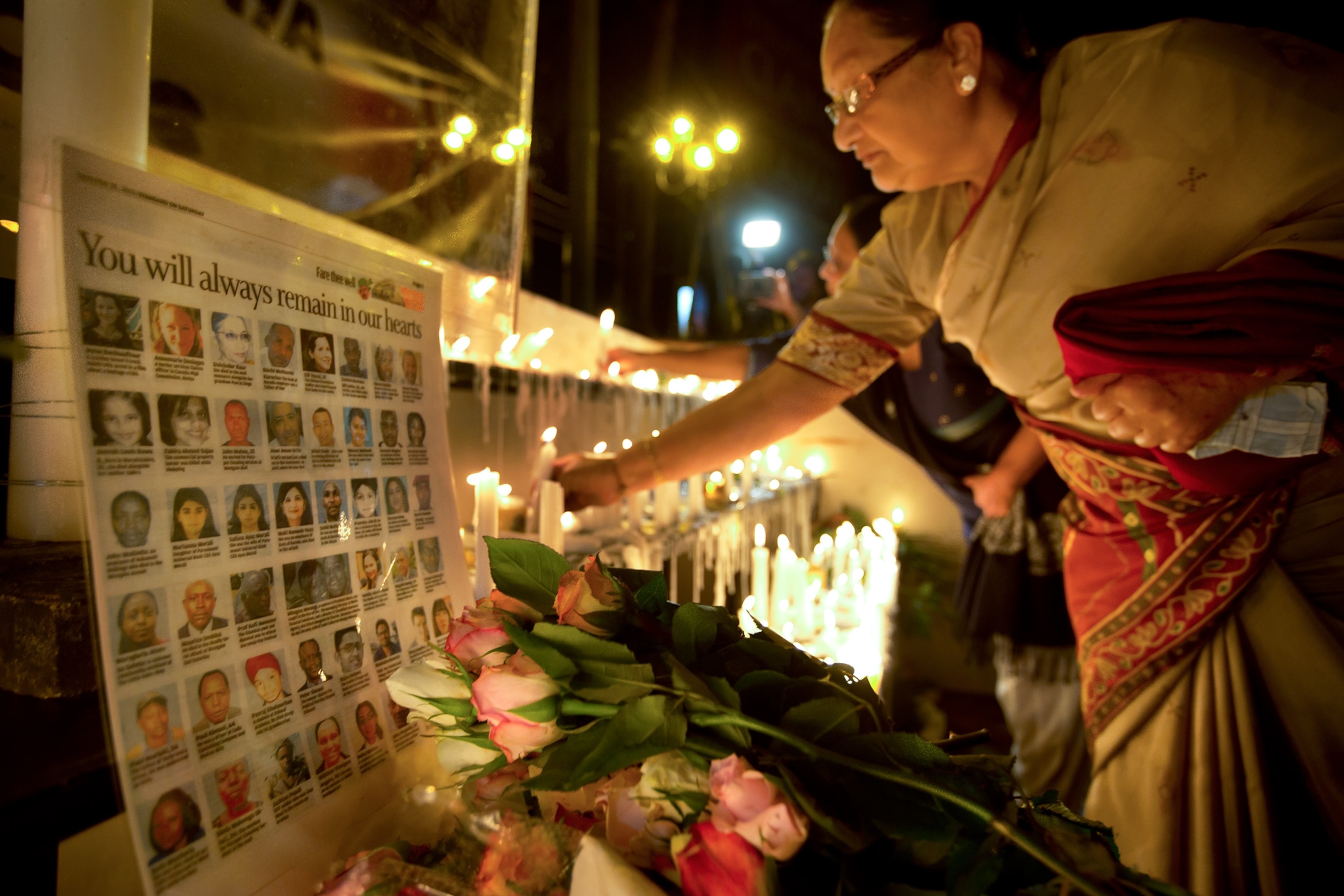 A visitor hugs a relative of Mitul Shah during his funeral.
