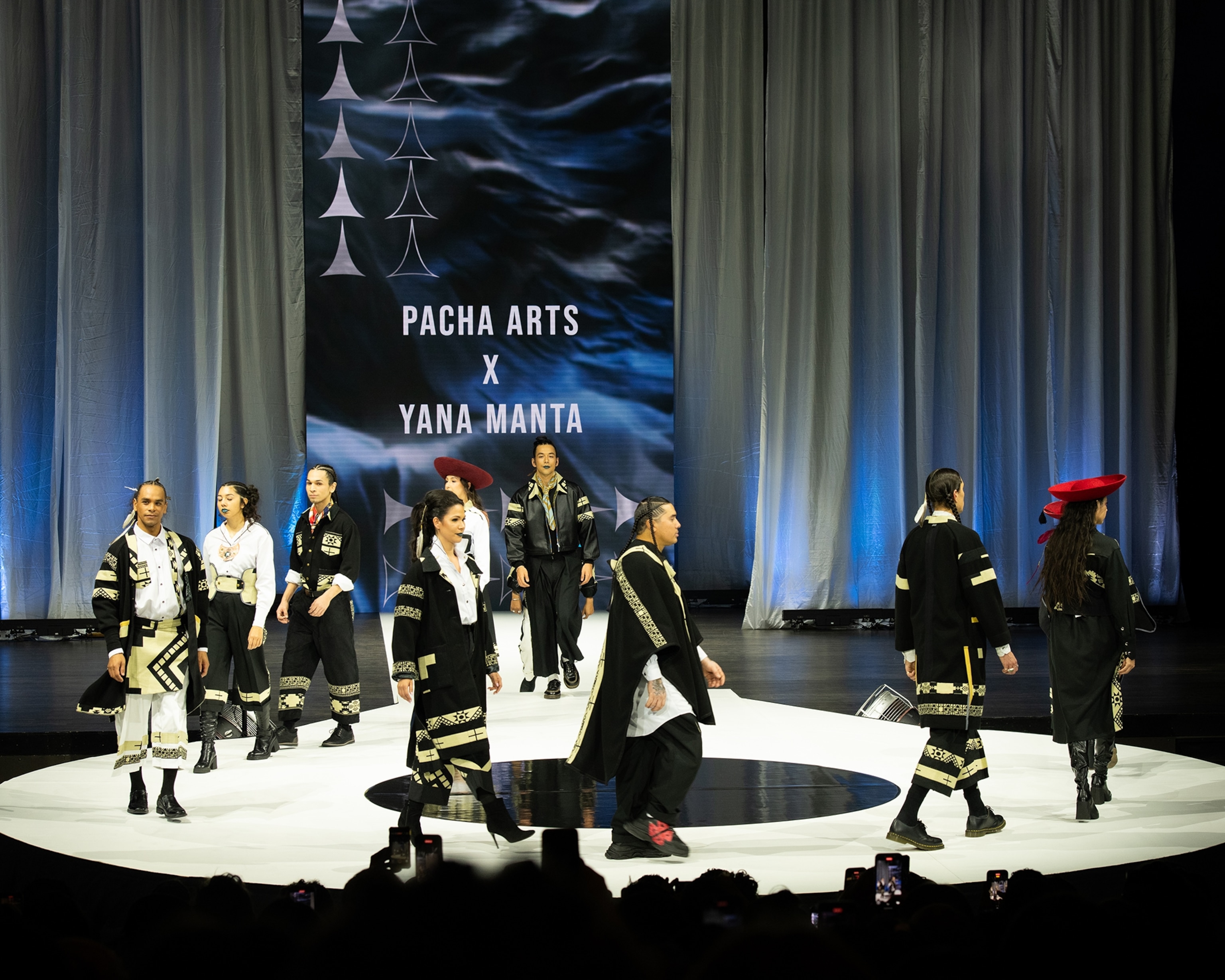 Models walk across the runway at Vancouver Indigenous Fashion Week 2025.