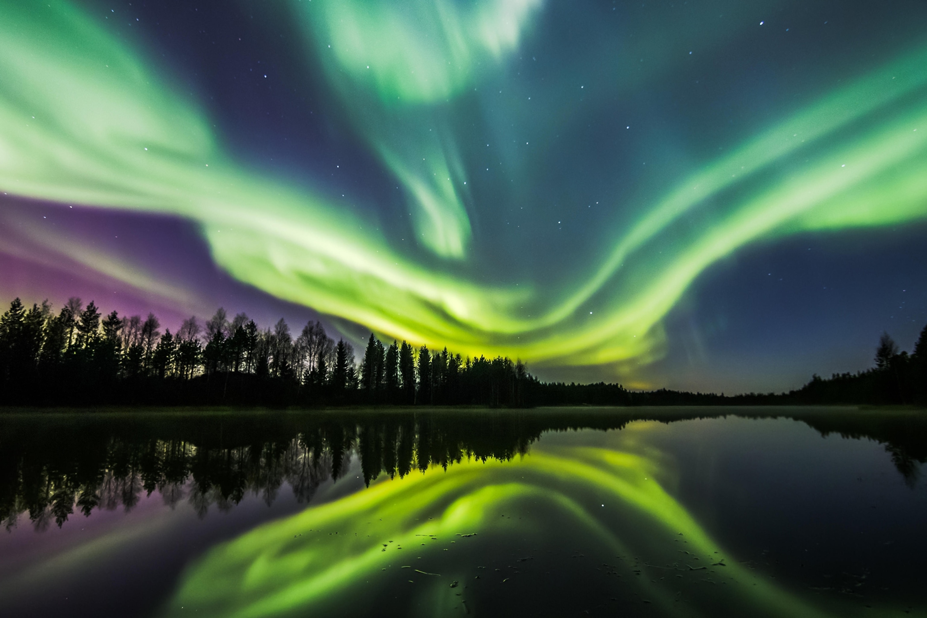 Northern Lights over a lake in Oulu, Finland.