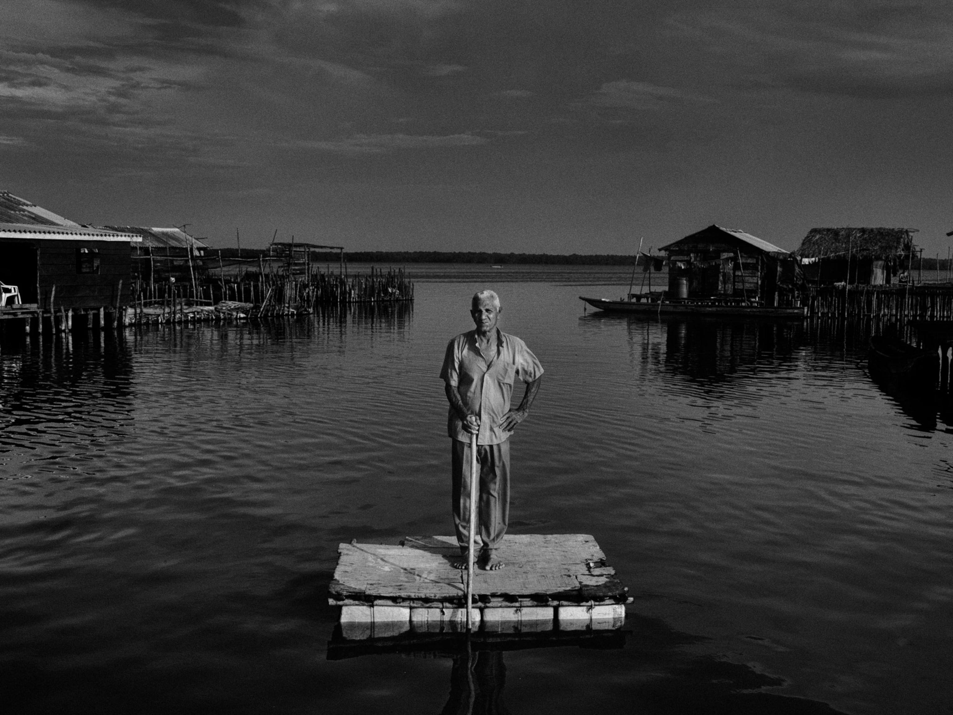 a man standing on a platform on the water