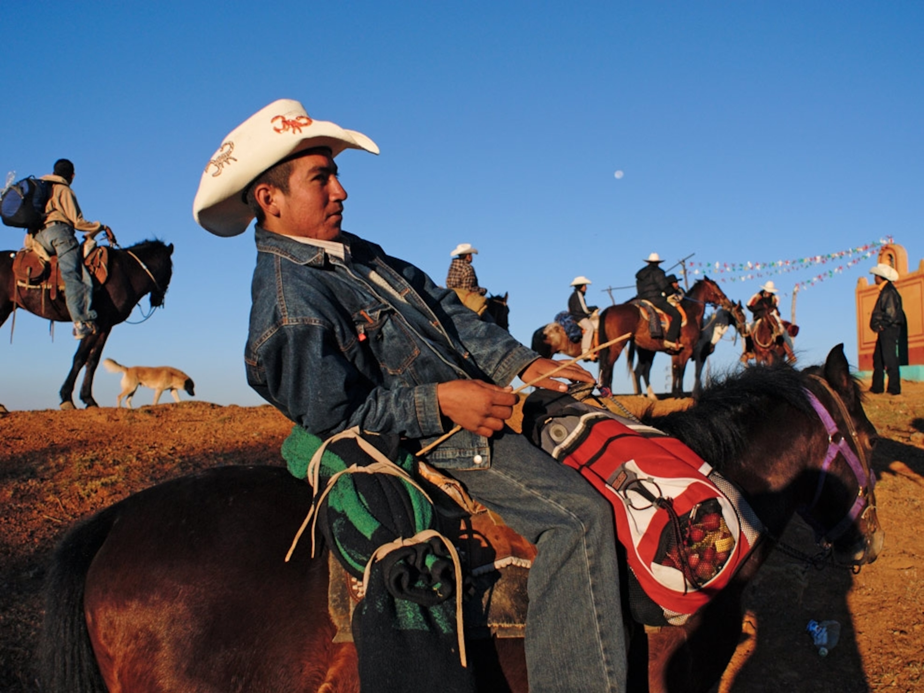 Men with cowboy hats on horseback