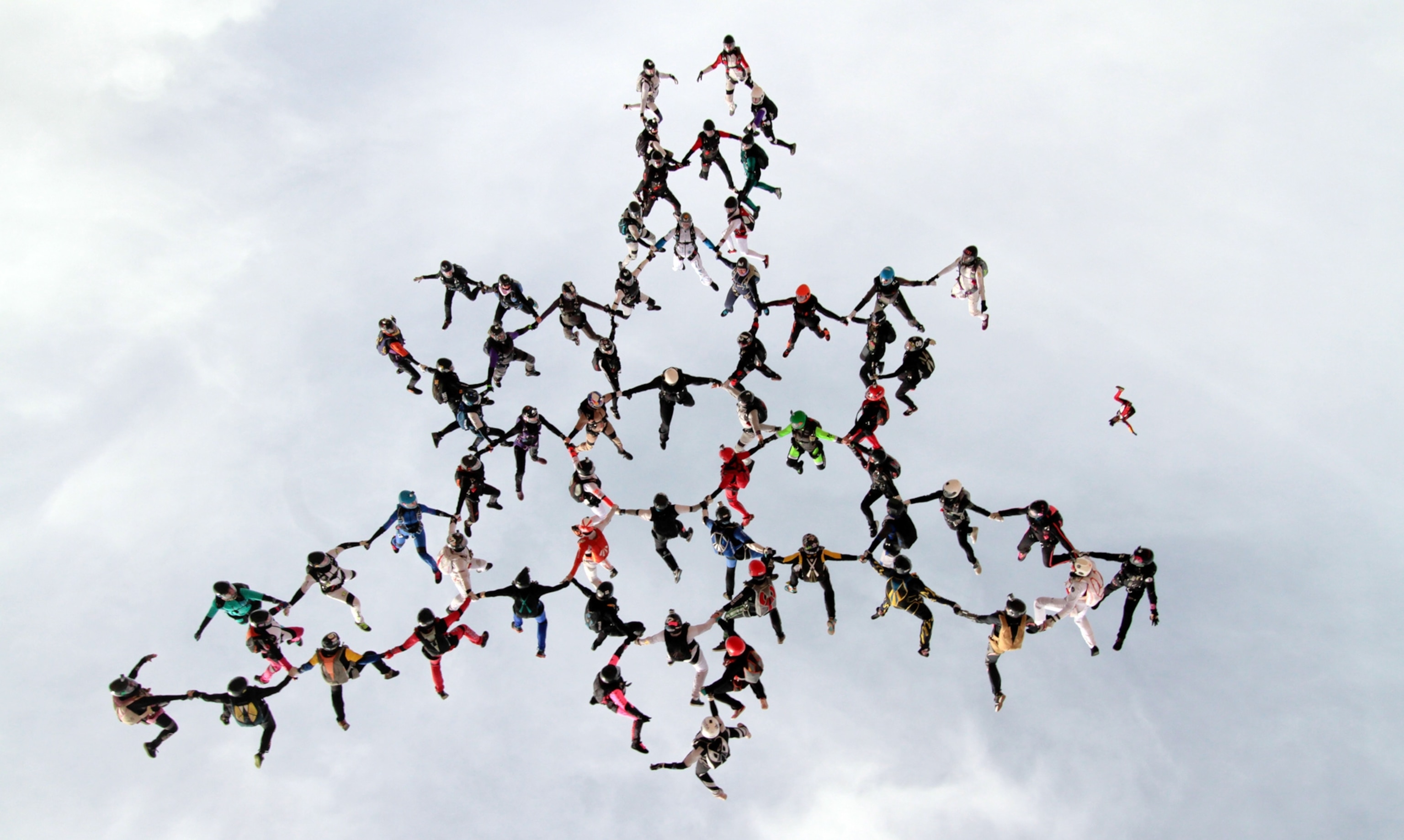 63 women skydivers setting a new world record for the largest all-female formation while jumping head down.