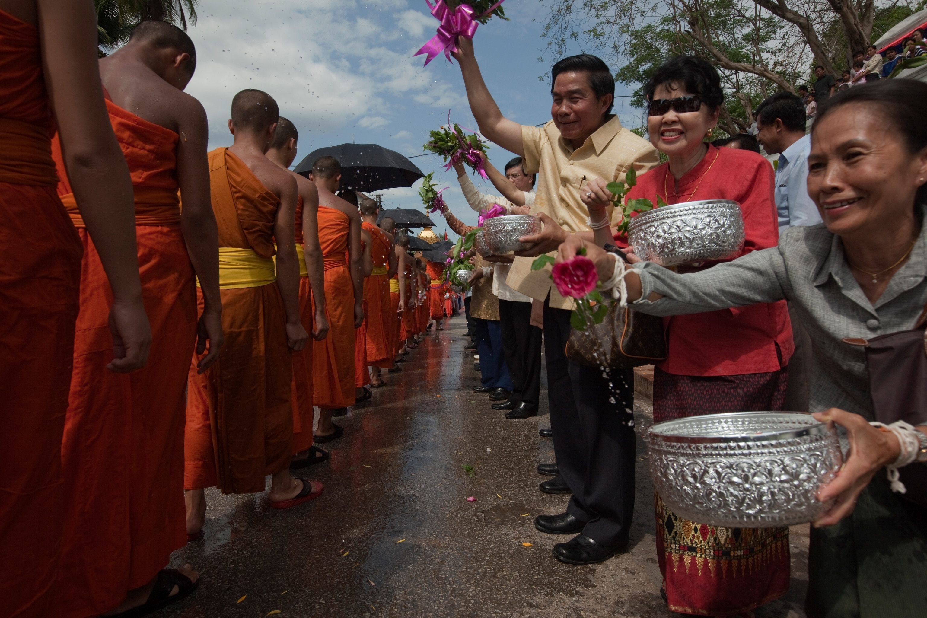 Onlookers splash water on the feet and bodies of passing Buddhist monks in Luang Prabang, Laos to celebrate the New Year. Known as Boun Pi Mai Lao, the mid-April celebration lasts for days and includes dancing, parades, and water throwing. In Buddhism, an offering of water is a symbol of purity, compassion, and impermanence.