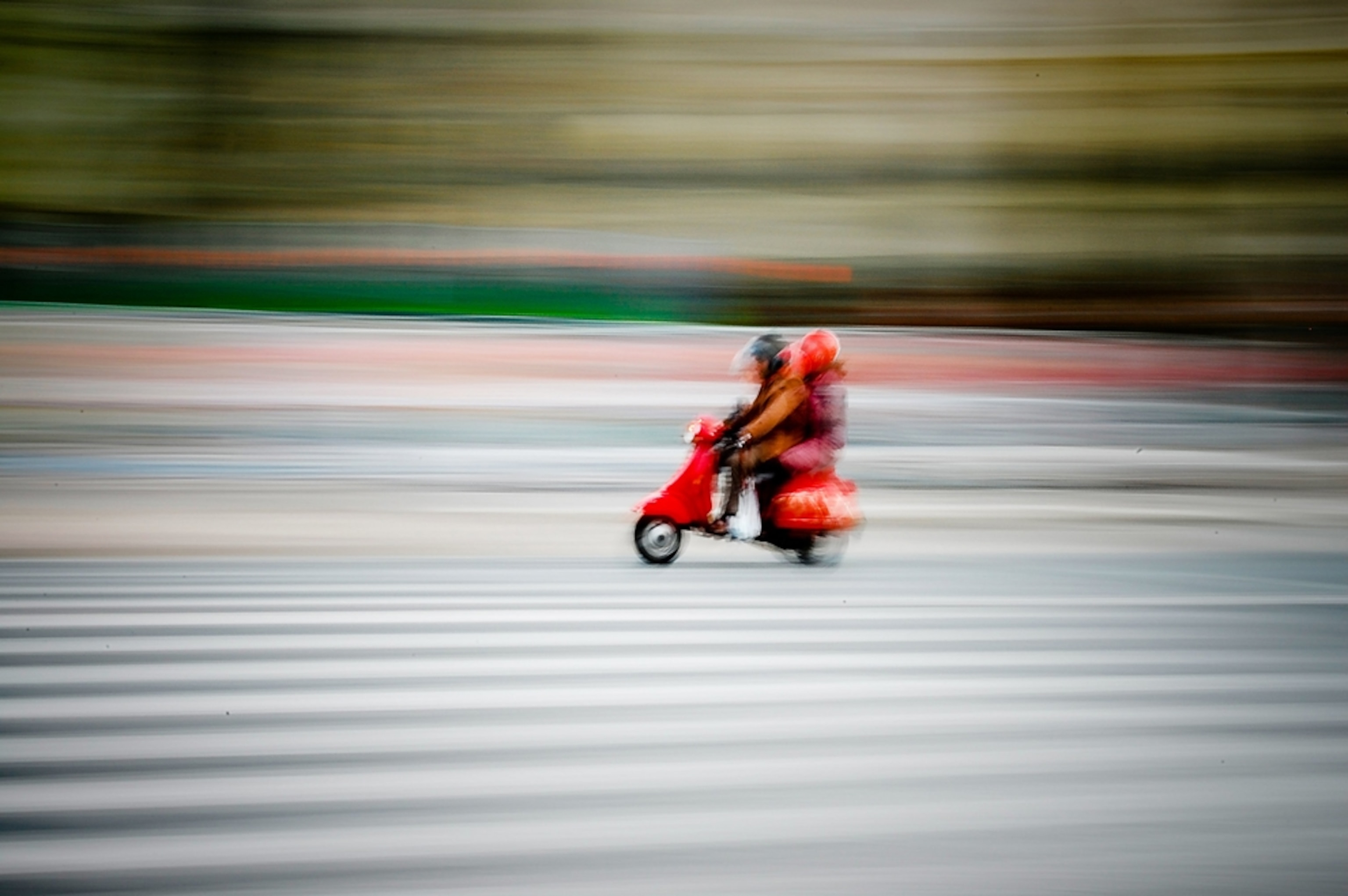Shot of people on a scooter in Spain