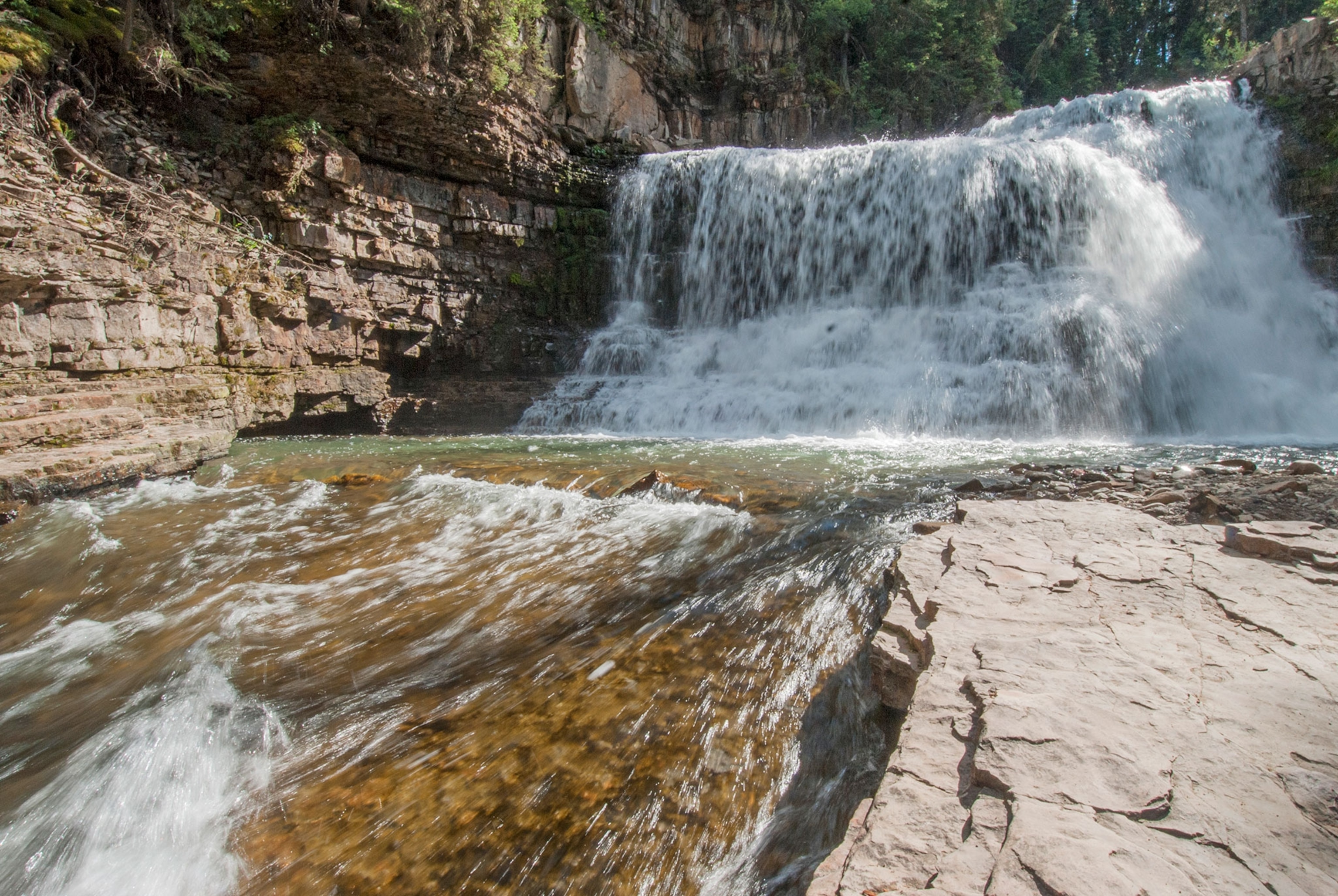 The West Fork of the Gallatin River pours over Ousel Falls in the Madison Range of the Rocky Mountains, near Big Sky, Montana.