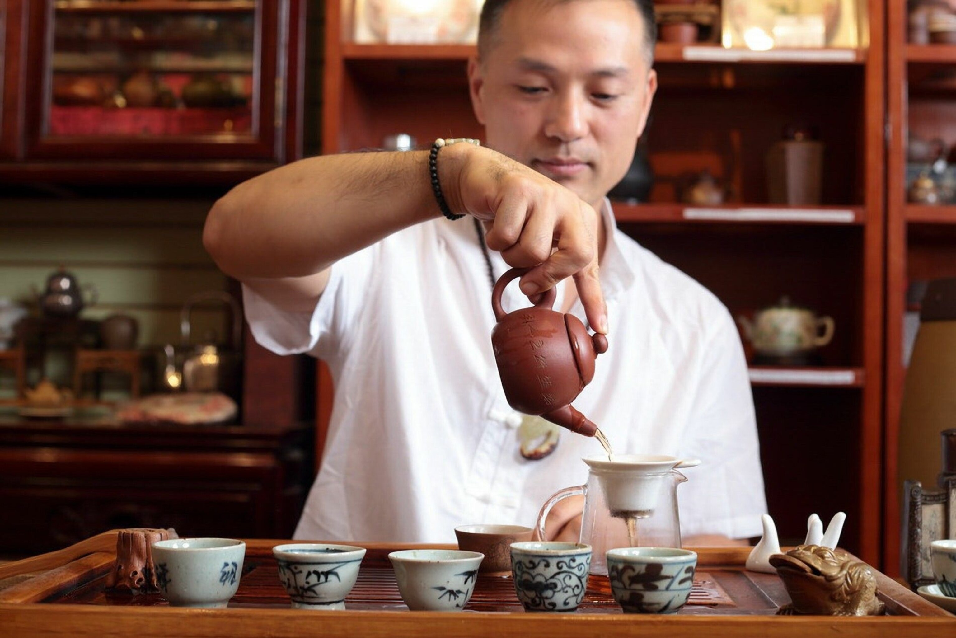 A Chinese man pours tea at The Chinese Tea Shop