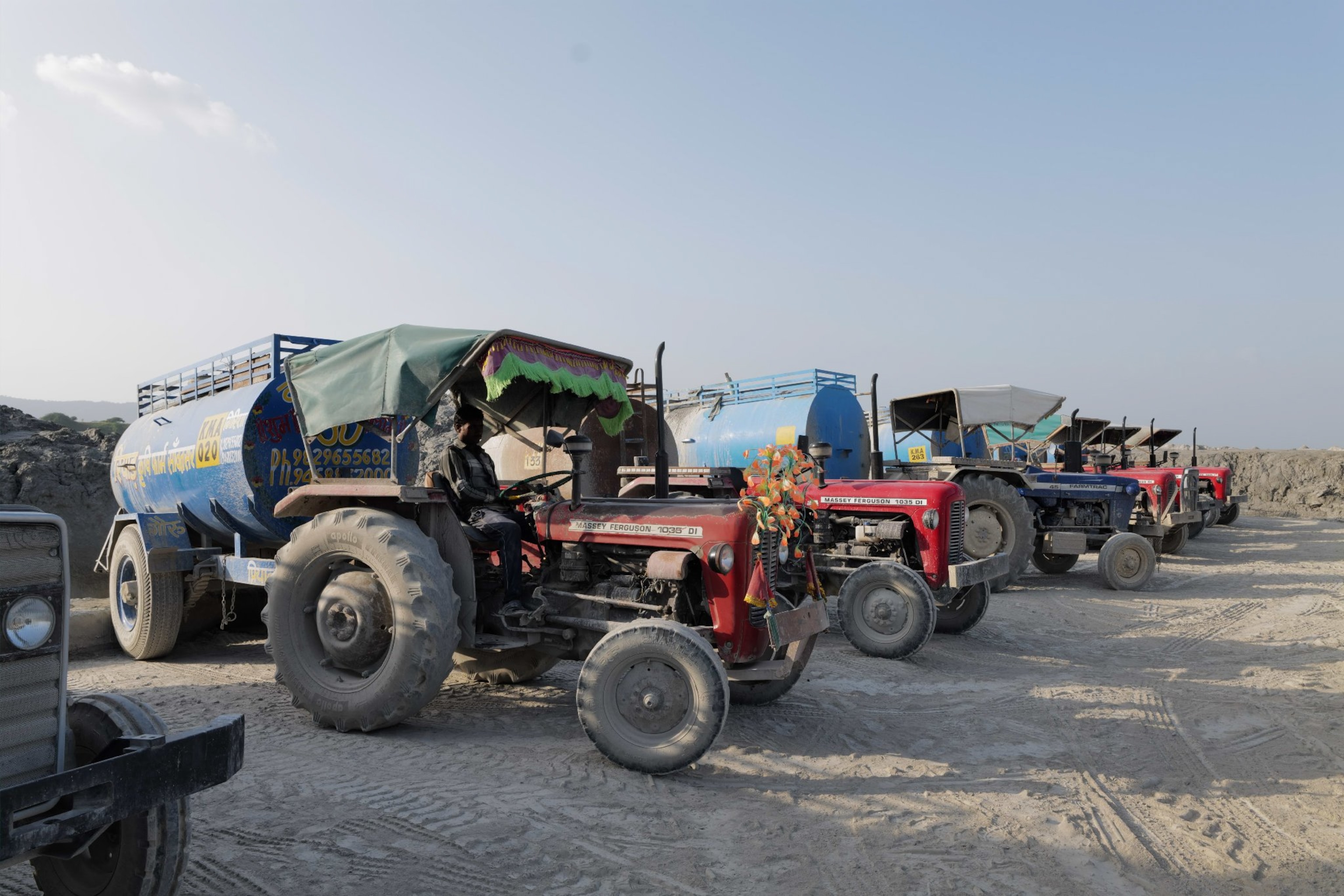 A row of trucks with decorations on the front.